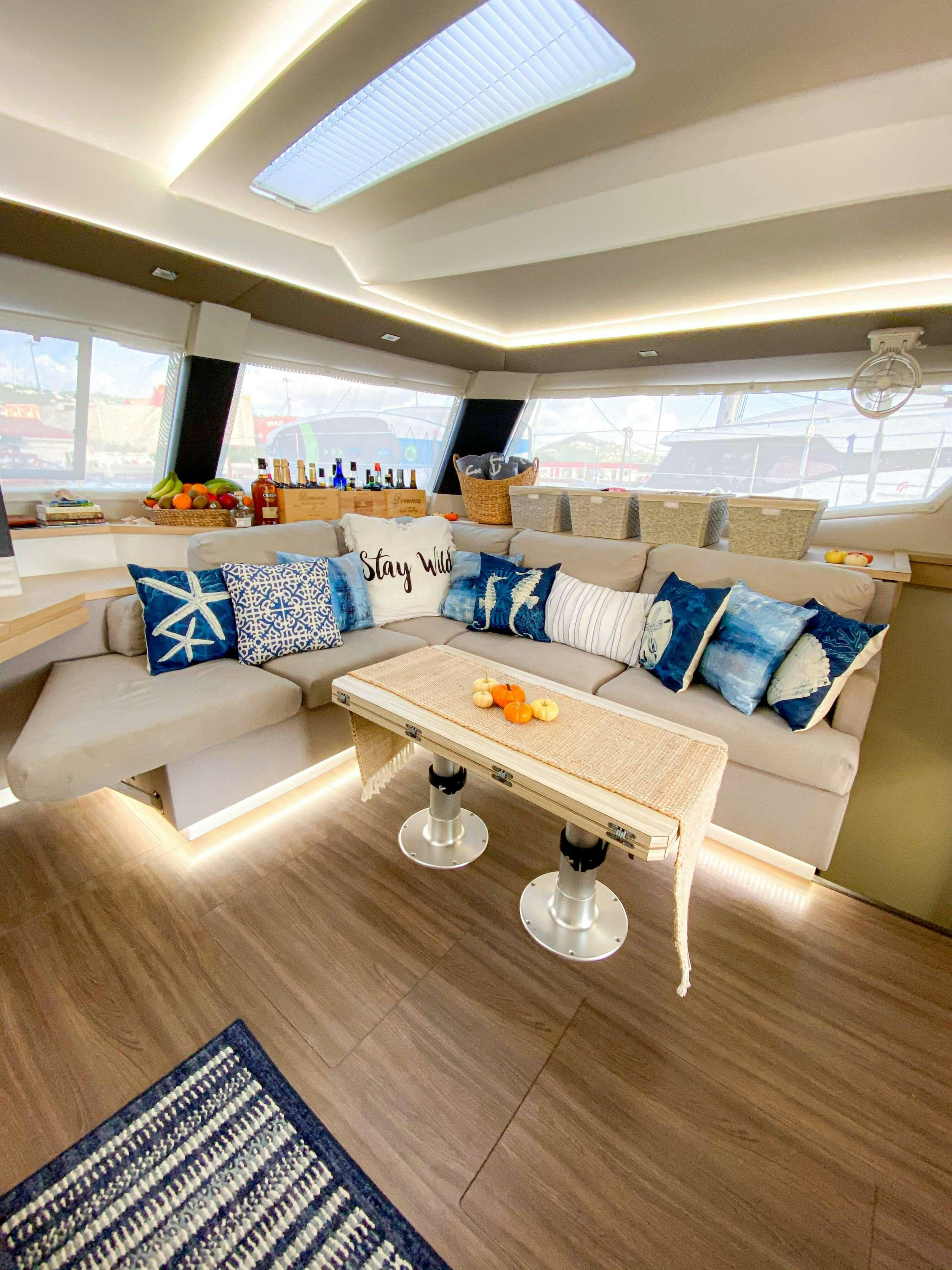 a living room with a couch and a table aboard Sol Mates Yacht for Charter