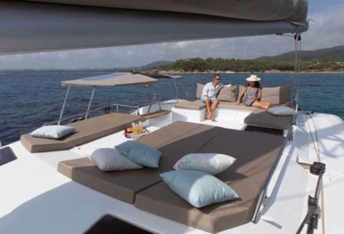 a boat with a couple of people on it aboard Sol Mates Yacht for Charter