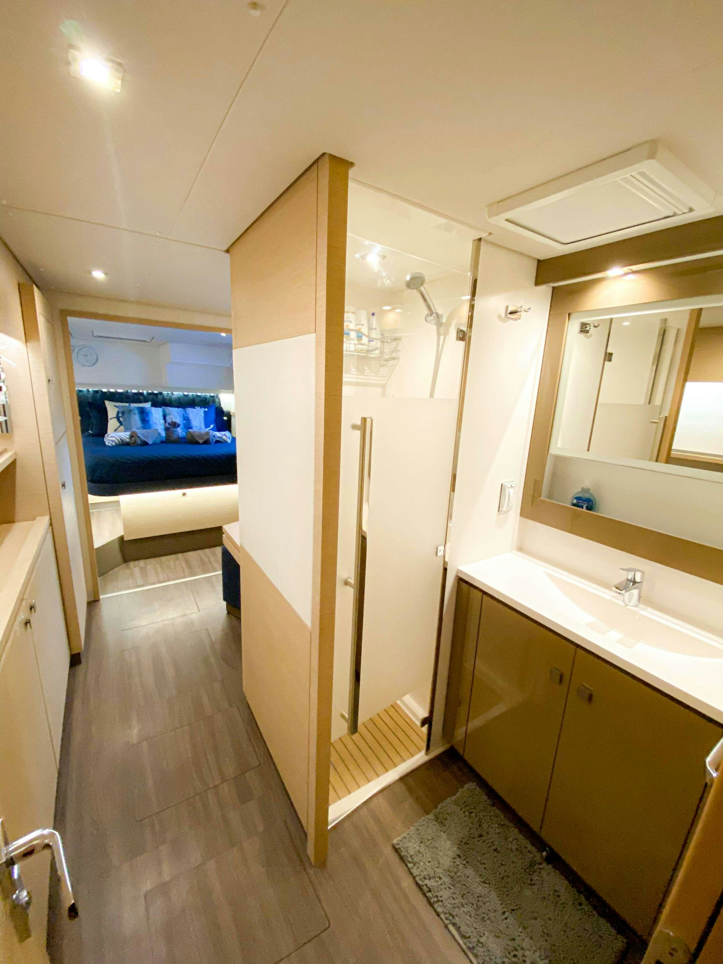 a bathroom with a tub sink and a mirror aboard Sol Mates Yacht for Charter