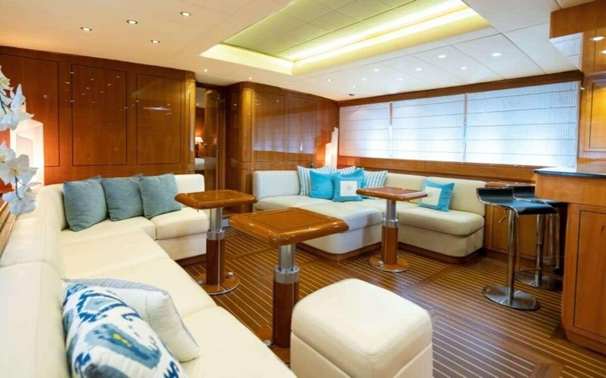 a living room with a couch and a table aboard HAPPY Yacht for Charter