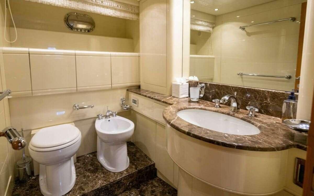a bathroom with a large mirror aboard HAPPY Yacht for Charter