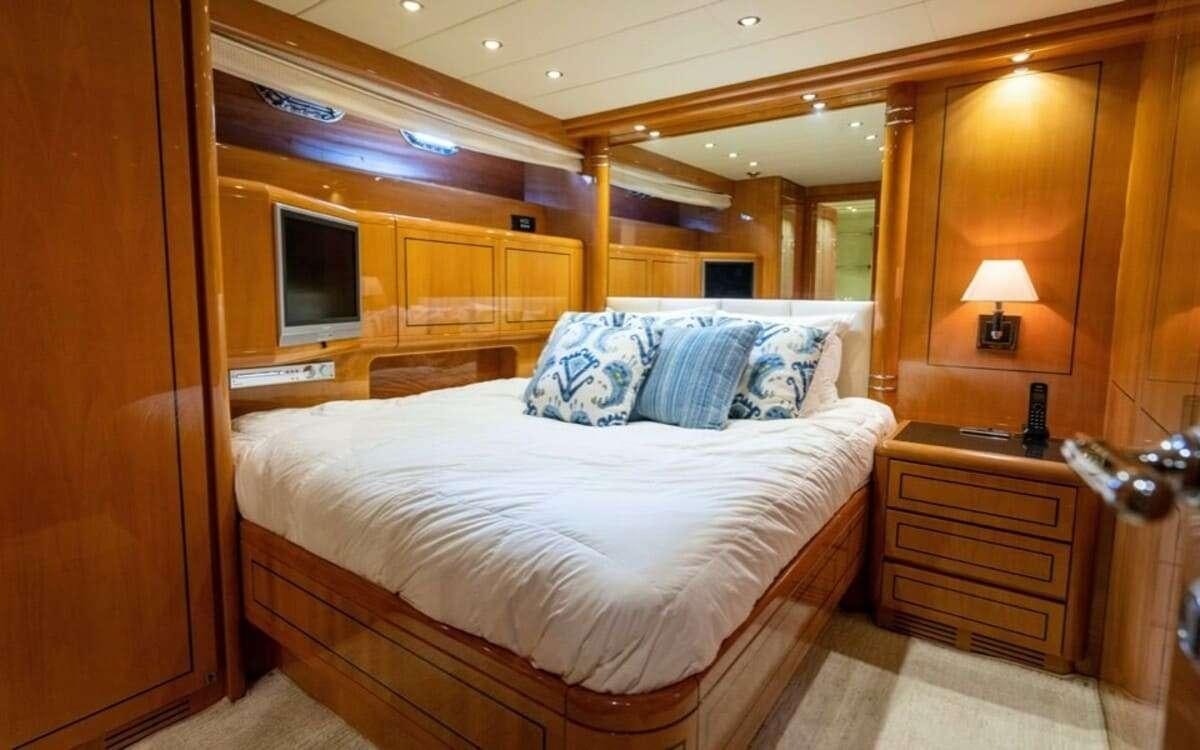 a bed in a cabin aboard HAPPY Yacht for Charter