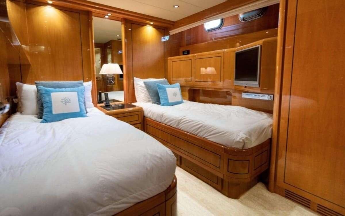 a room with a couple of beds aboard HAPPY Yacht for Charter