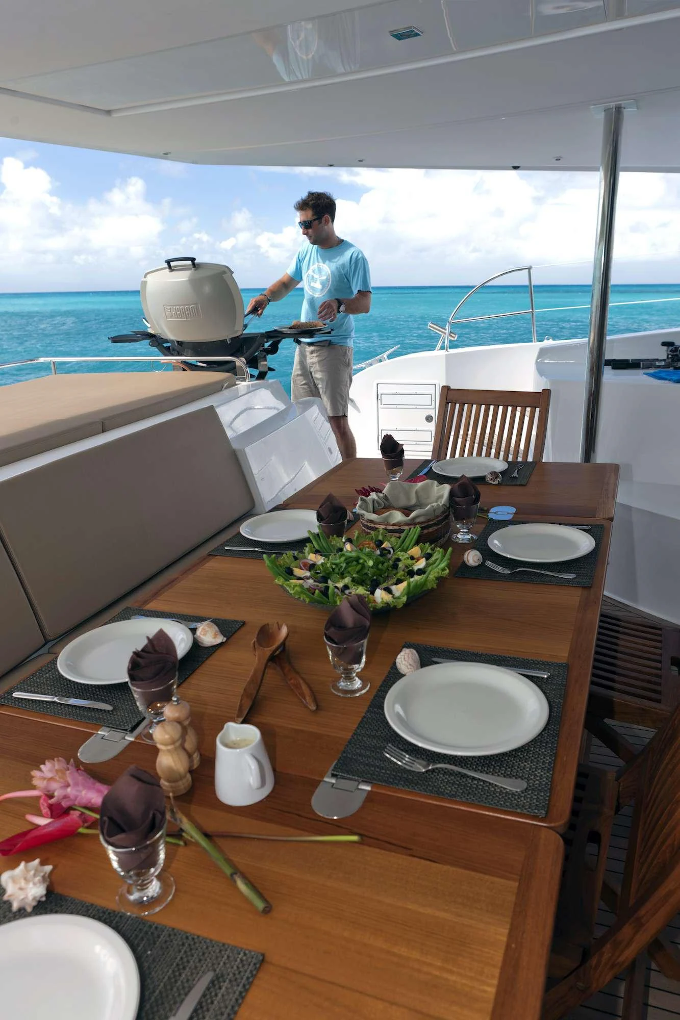 a person standing on a balcony overlooking the ocean aboard GRATITUDE Yacht for Charter