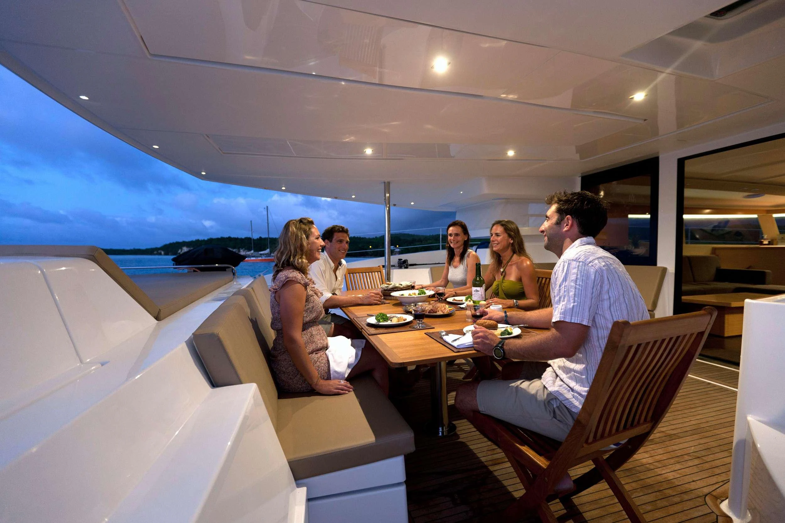 a group of people sitting around a table aboard GRATITUDE Yacht for Charter