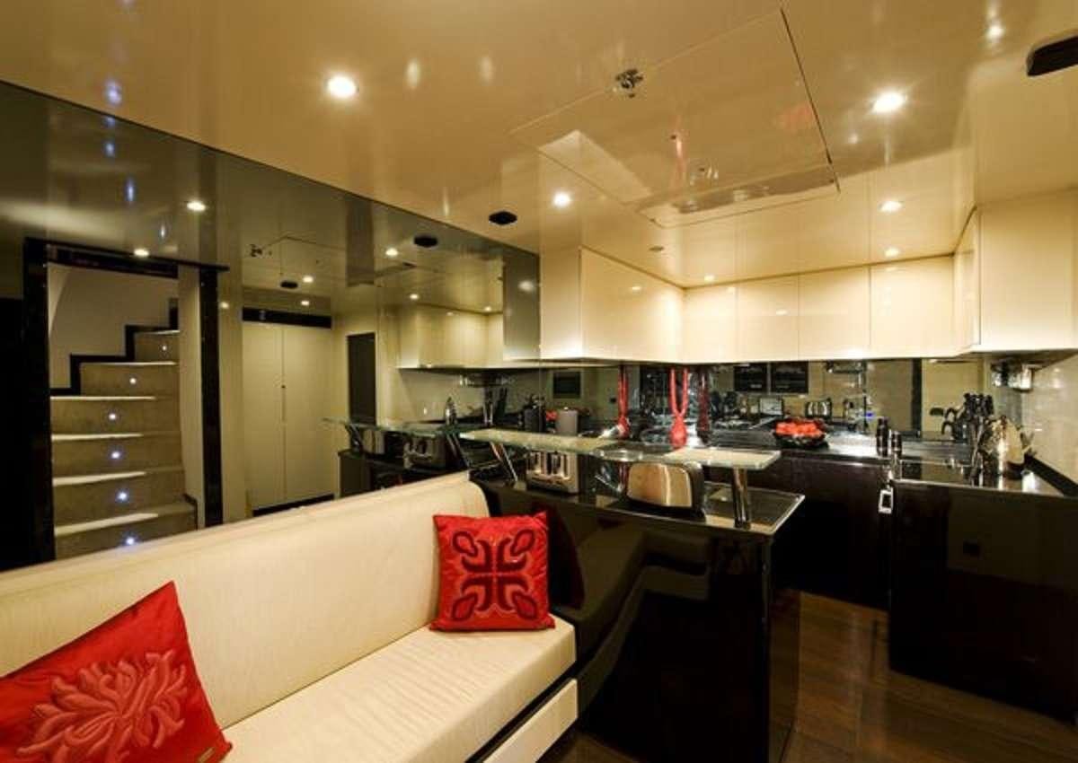 a room with a bed and a table aboard CLAREMONT Yacht for Charter