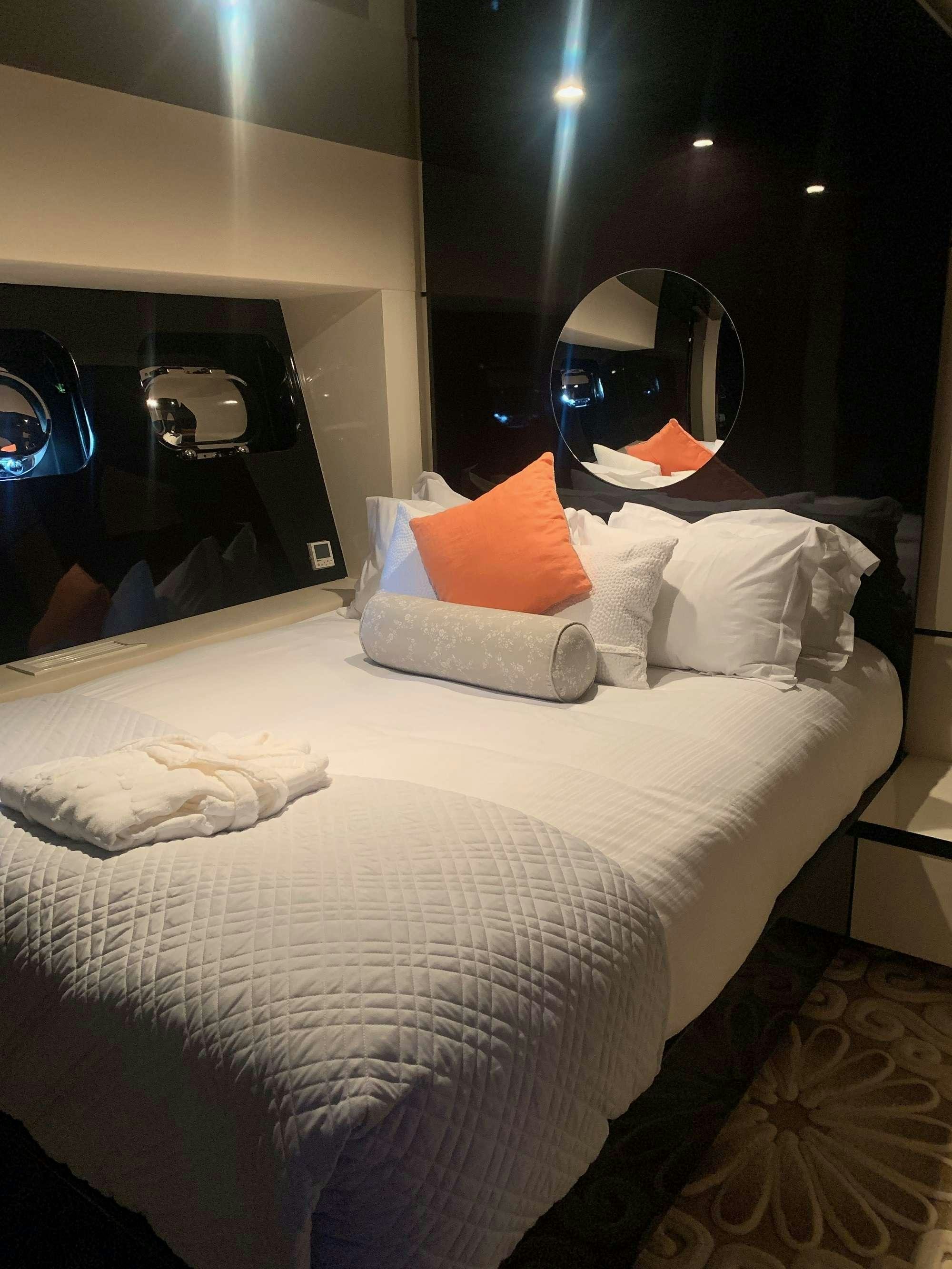 a bed with a white bed spread aboard CLAREMONT Yacht for Charter