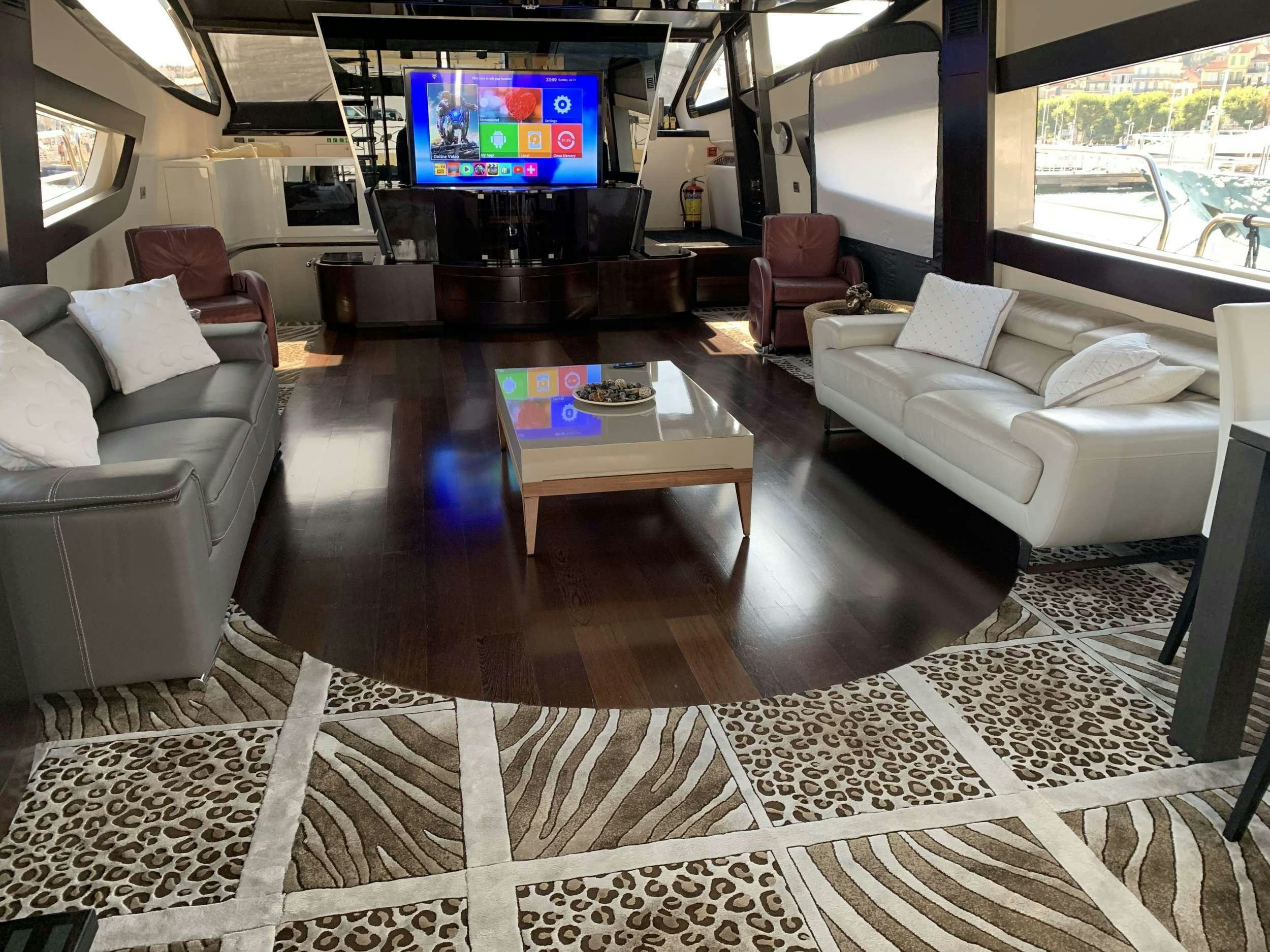a living room with a large tv aboard CLAREMONT Yacht for Charter
