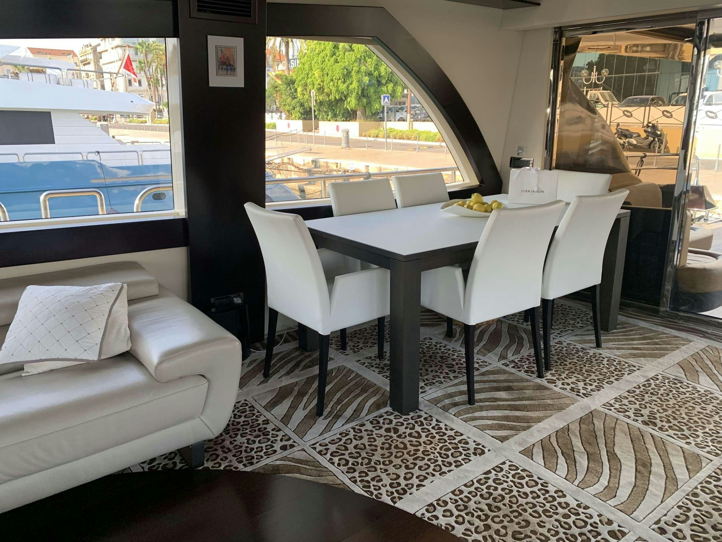 a room with a table and chairs aboard CLAREMONT Yacht for Charter