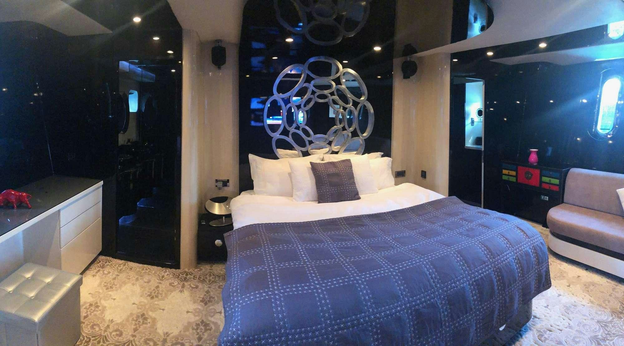 a bedroom with a large bed aboard CLAREMONT Yacht for Charter