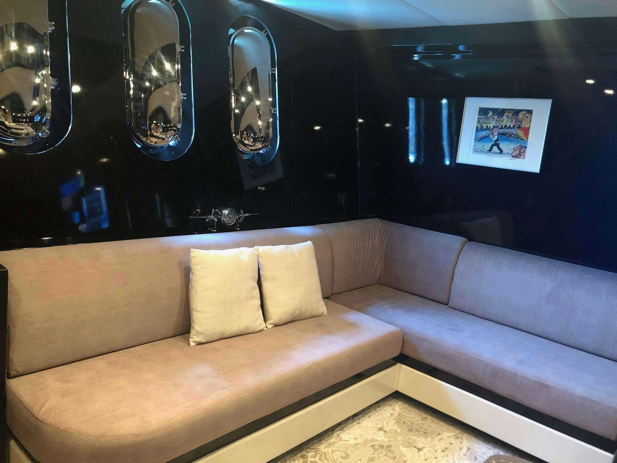 a couch in a room aboard CLAREMONT Yacht for Charter