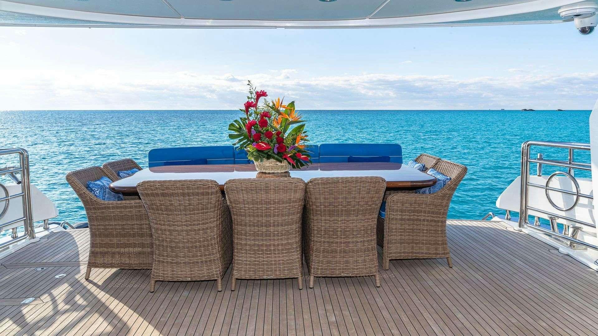 a group of chairs on a deck overlooking a body of water aboard KEFI Yacht for Charter