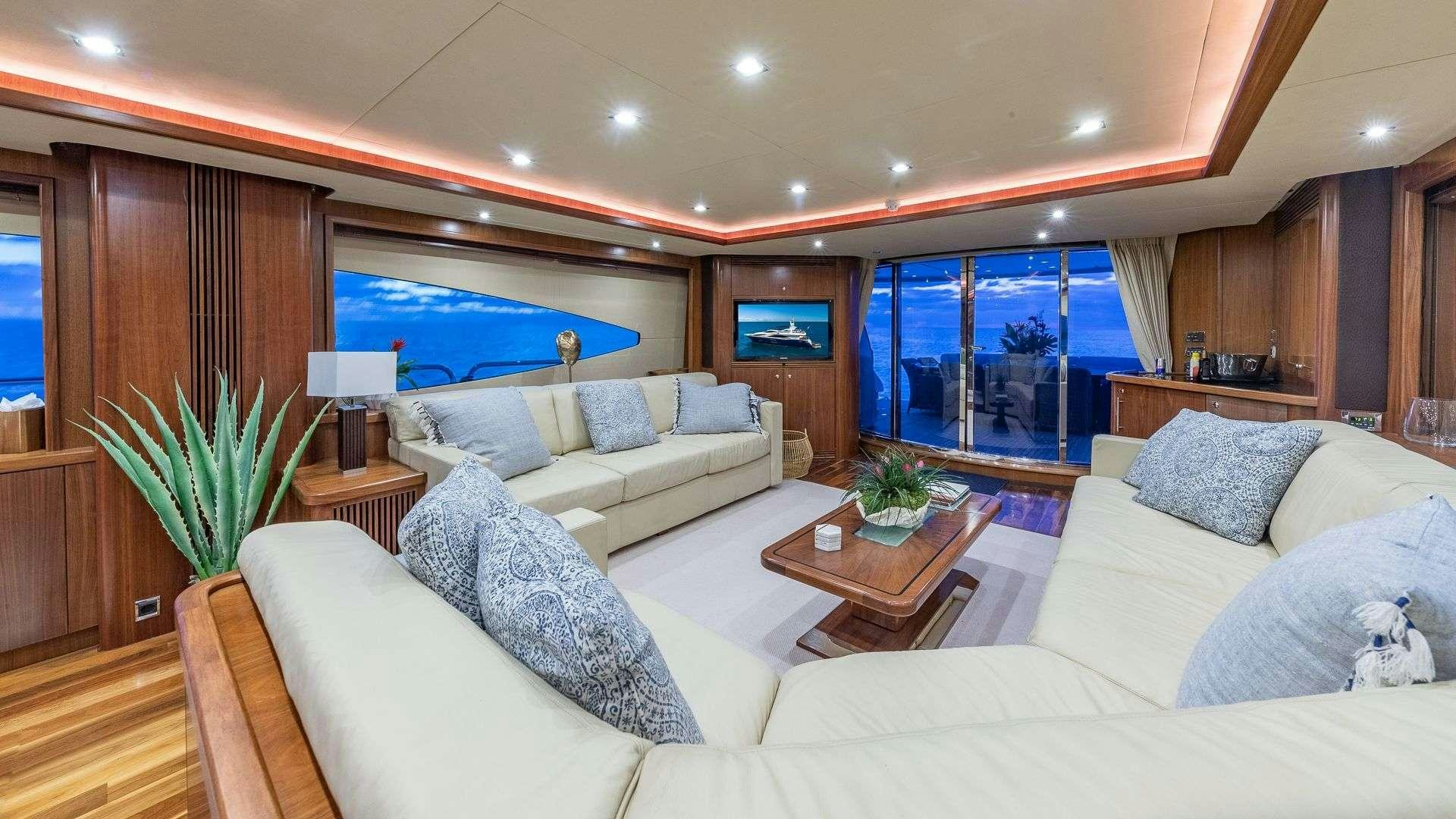 a living room with a large window aboard KEFI Yacht for Charter