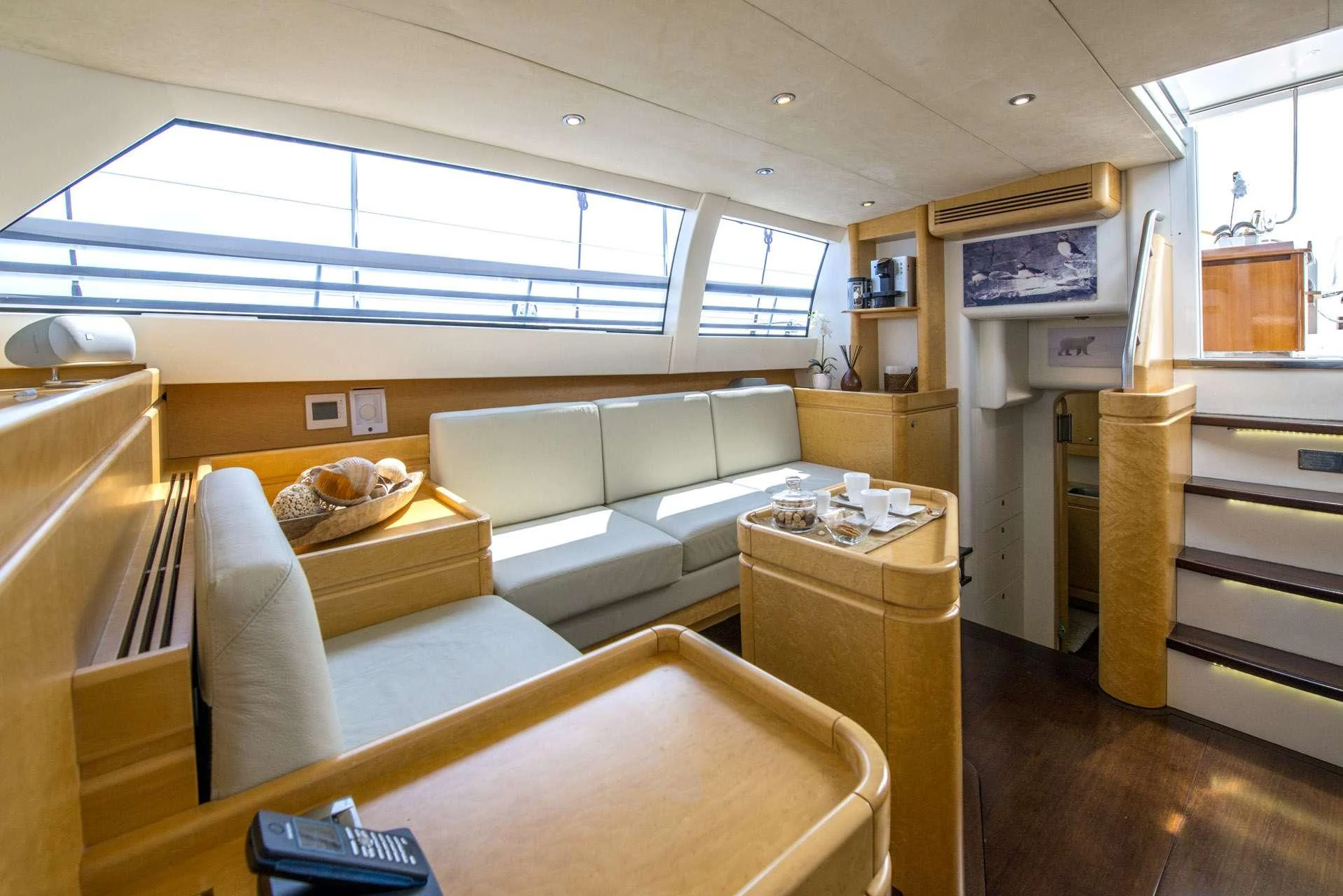 a living room with a couch and a table aboard LADY 8 Yacht for Charter