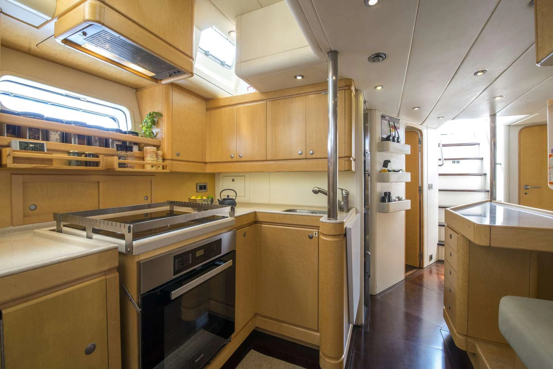 a kitchen with wooden cabinets aboard LADY 8 Yacht for Charter