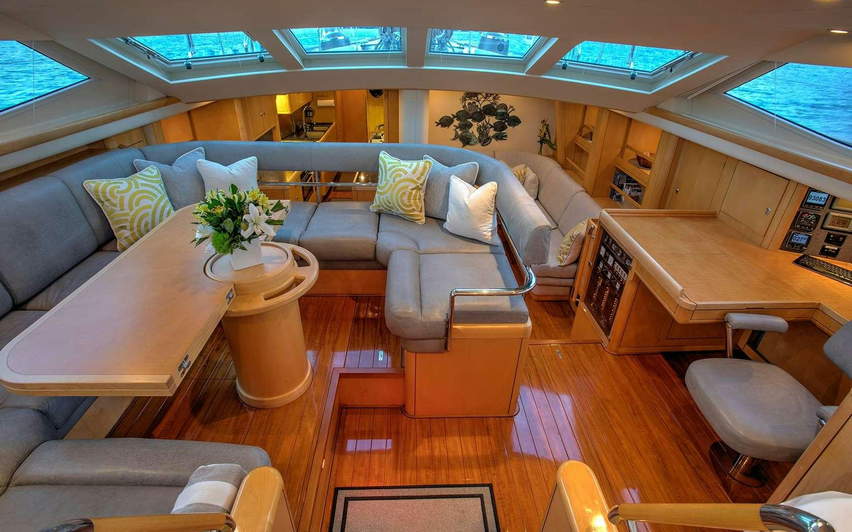 a living room with a couch and coffee table aboard DAMA DE NOCHE Yacht for Charter