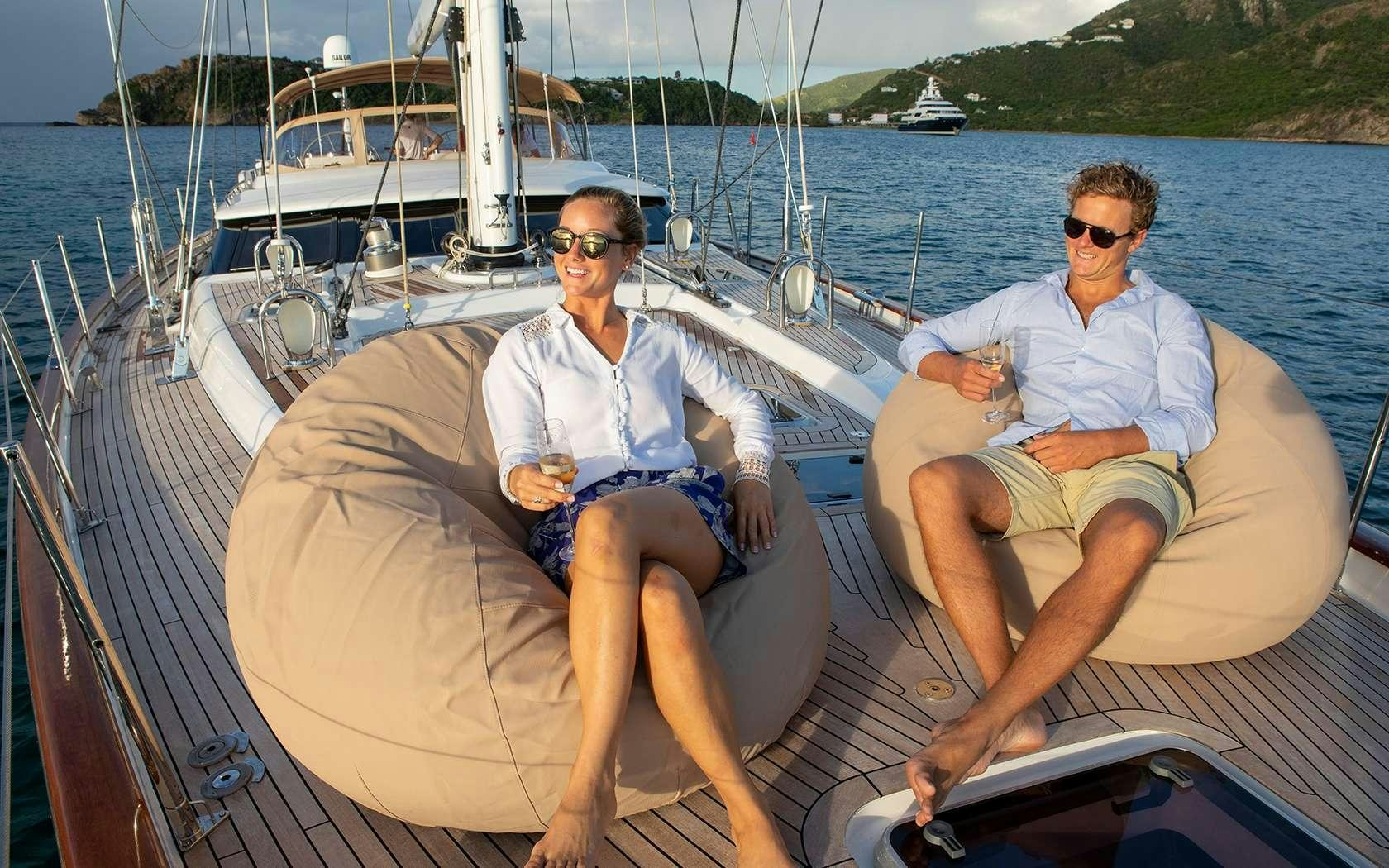 two men sitting on a boat aboard DAMA DE NOCHE Yacht for Charter