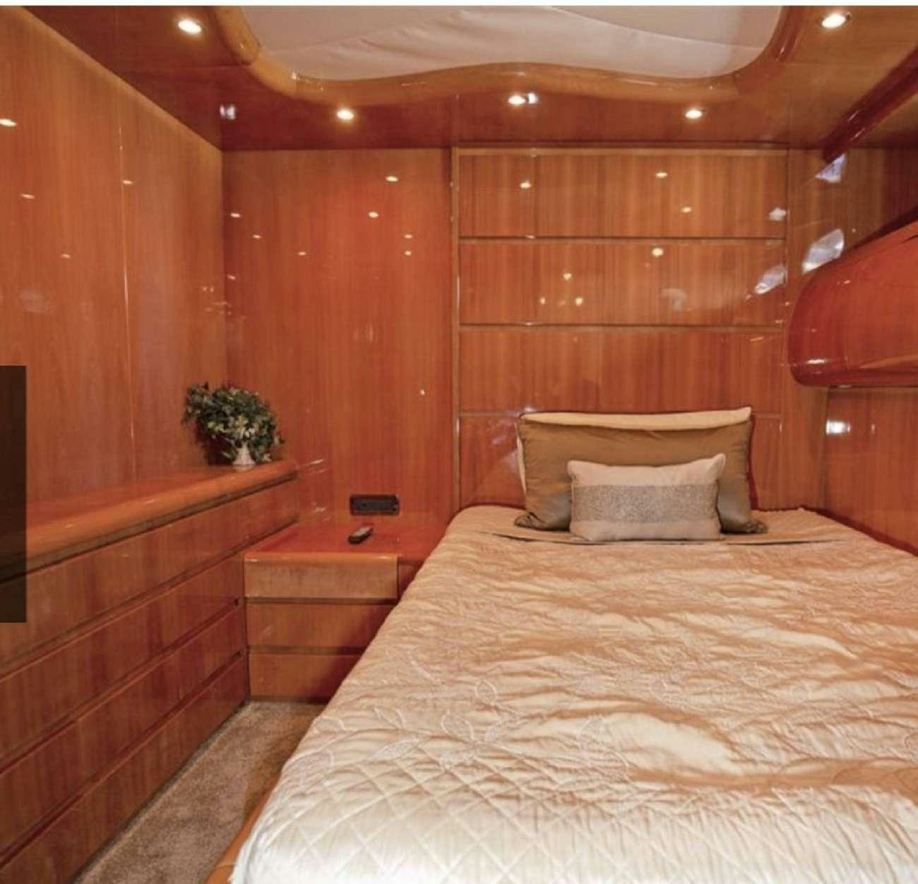 a bed in a cabin aboard 103' CUSTOM BUILD Yacht for Charter
