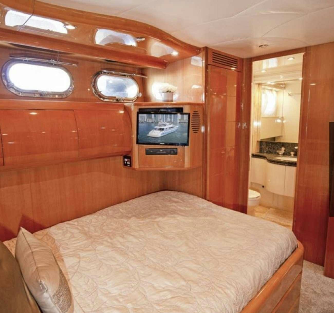 a bed in a room aboard 103' CUSTOM BUILD Yacht for Charter