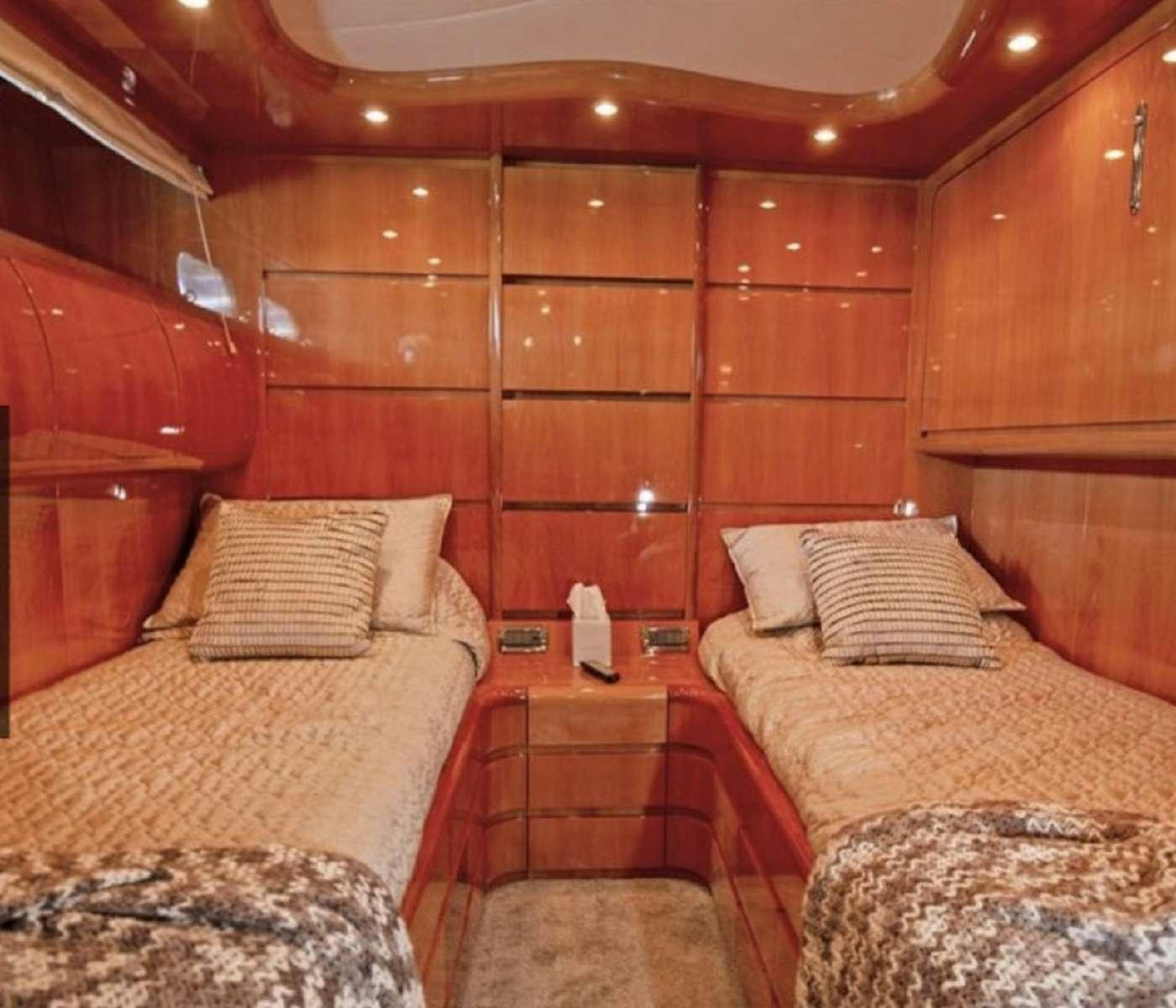a room with a couple of beds aboard 103' CUSTOM BUILD Yacht for Charter