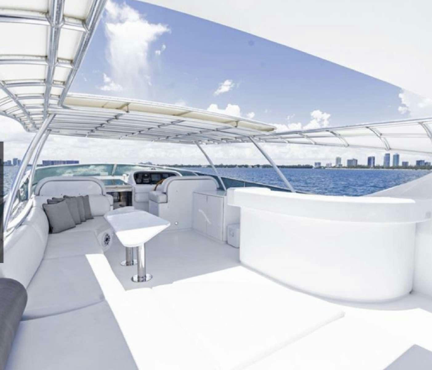 a lounge area with a large white lounge chair and a large swimming pool aboard 103' CUSTOM BUILD Yacht for Charter