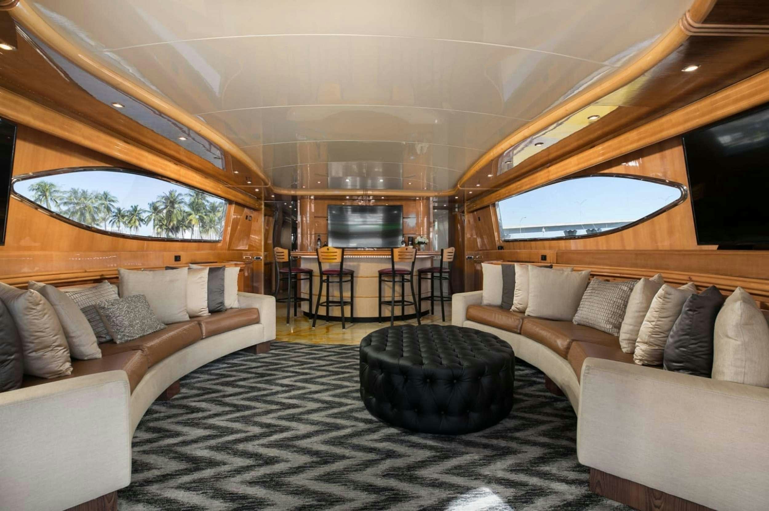 a living room with a large window aboard 103' CUSTOM BUILD Yacht for Charter