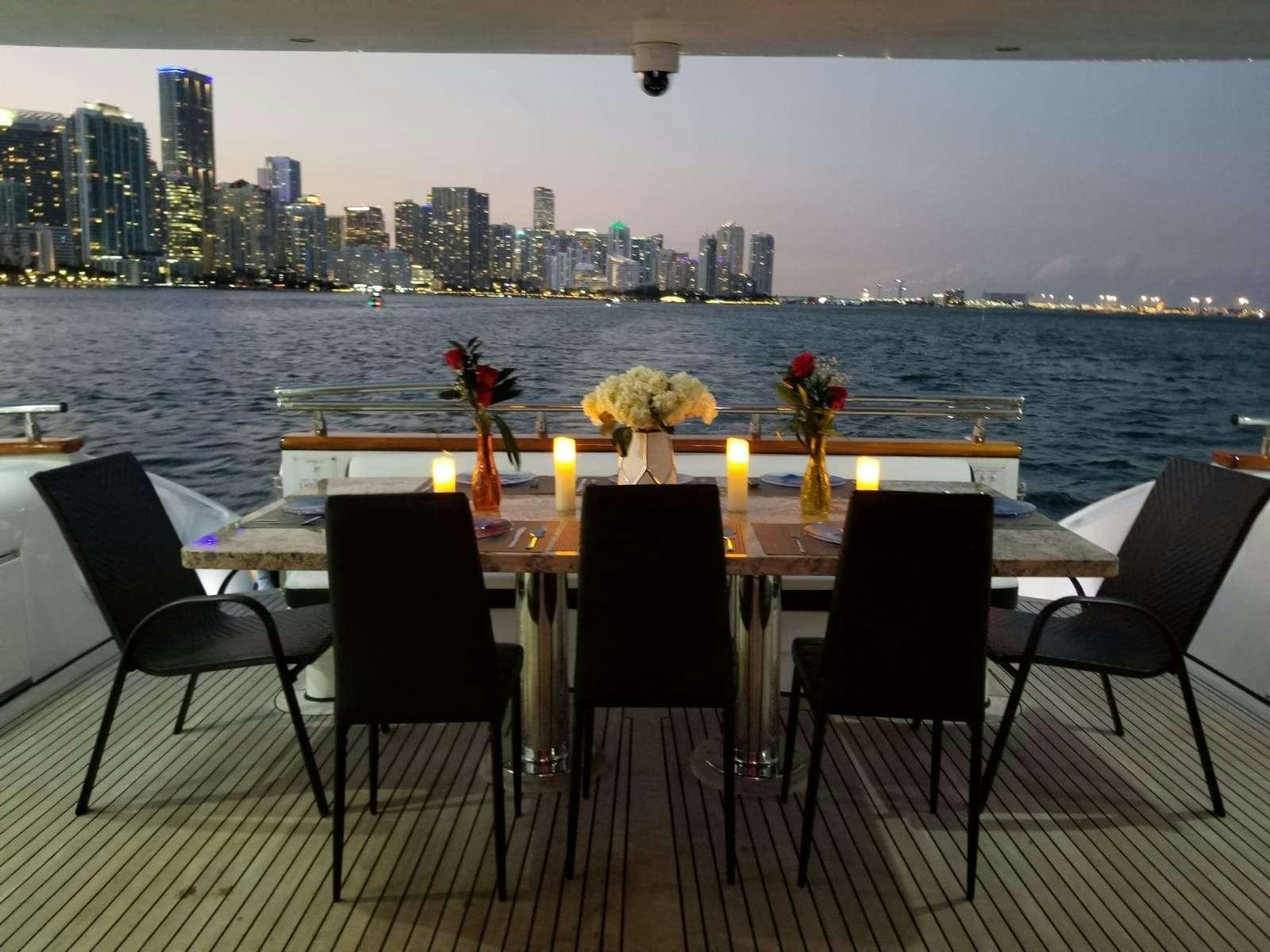 a table with candles and flowers on it aboard 103' CUSTOM BUILD Yacht for Charter