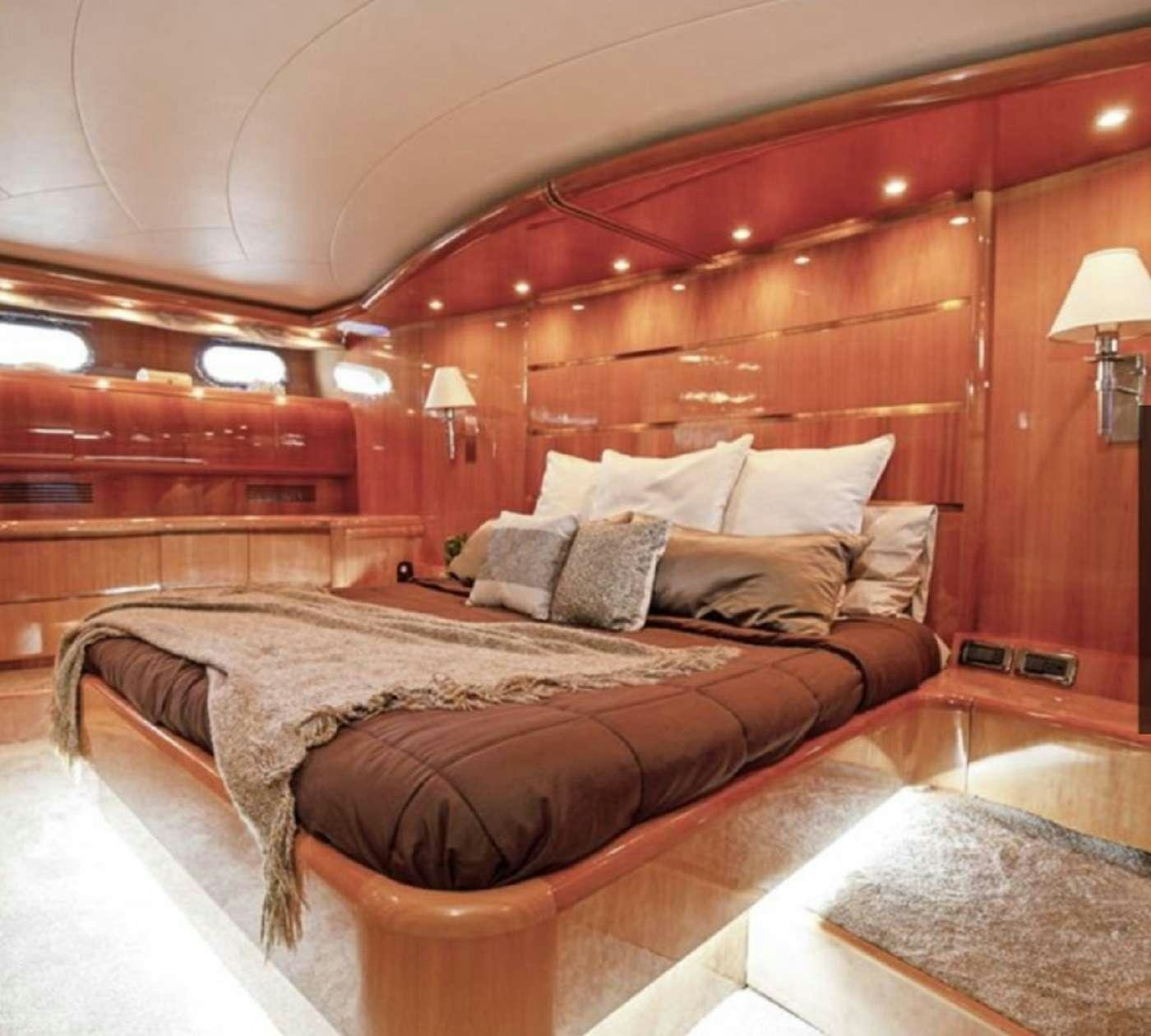 a bed in a room aboard 103' CUSTOM BUILD Yacht for Charter