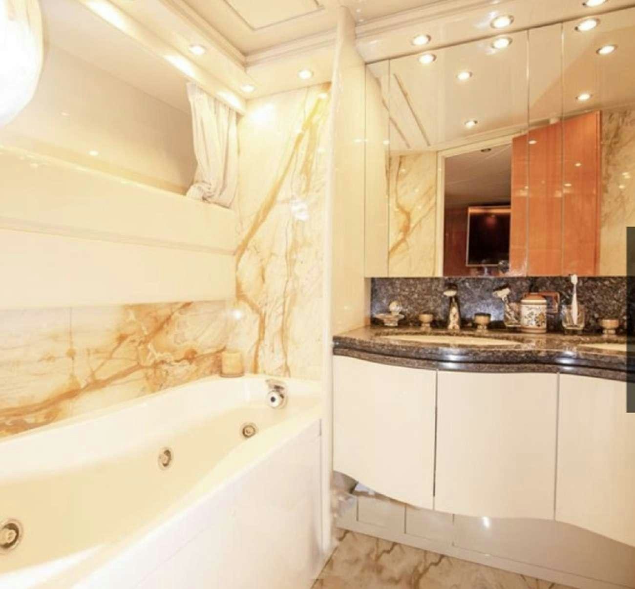 a bathroom with a bathtub and sink aboard 103' CUSTOM BUILD Yacht for Charter