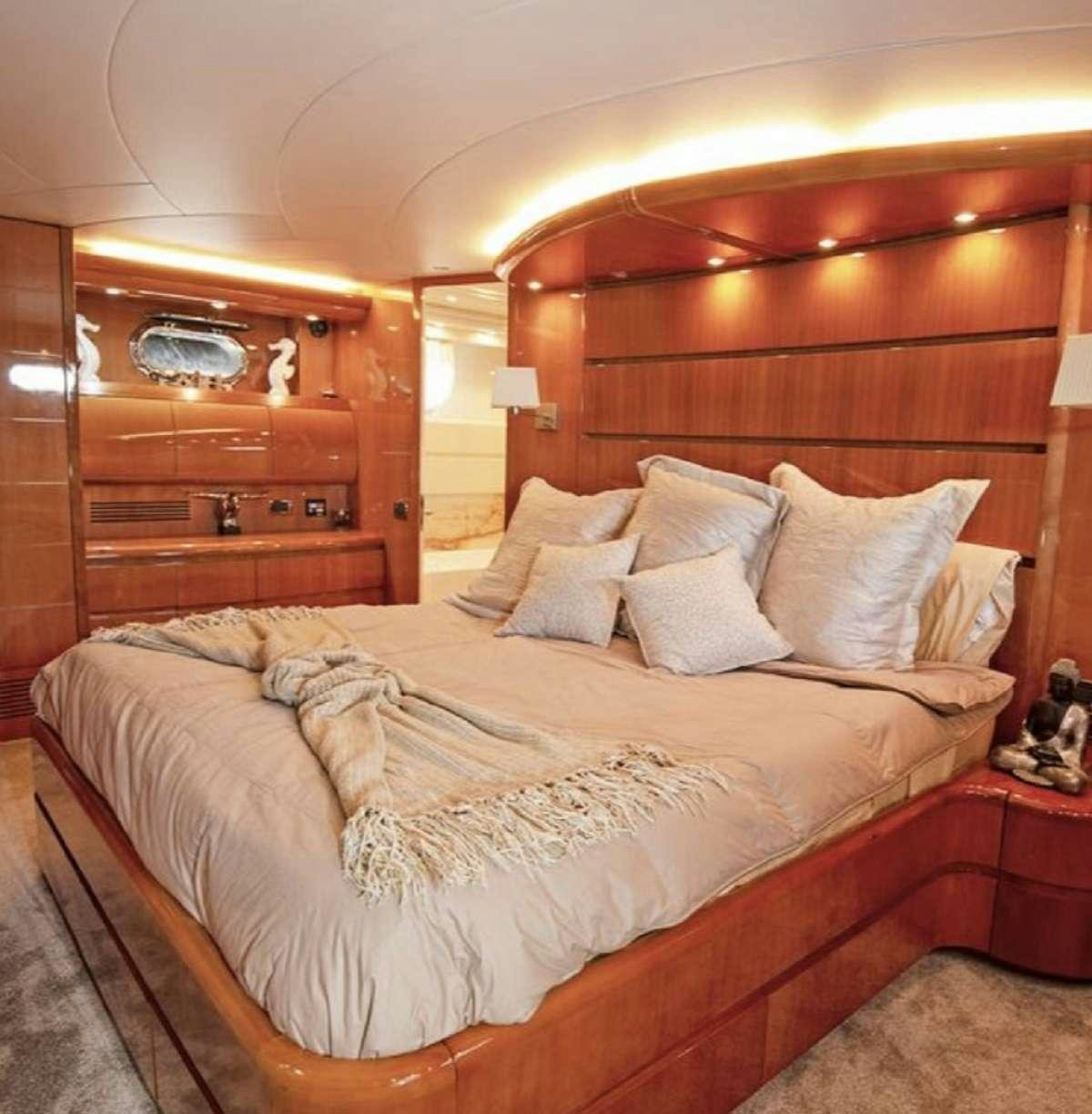 a bed with white sheets aboard 103' CUSTOM BUILD Yacht for Charter