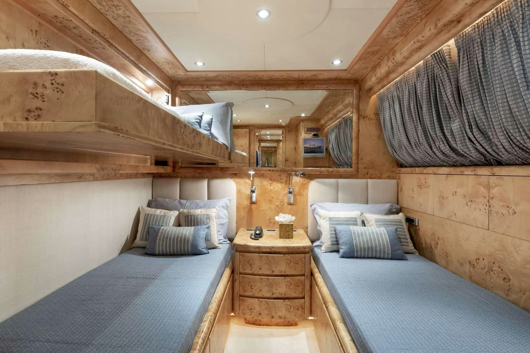 a room with a bed and a table aboard ANDILIS Yacht for Charter