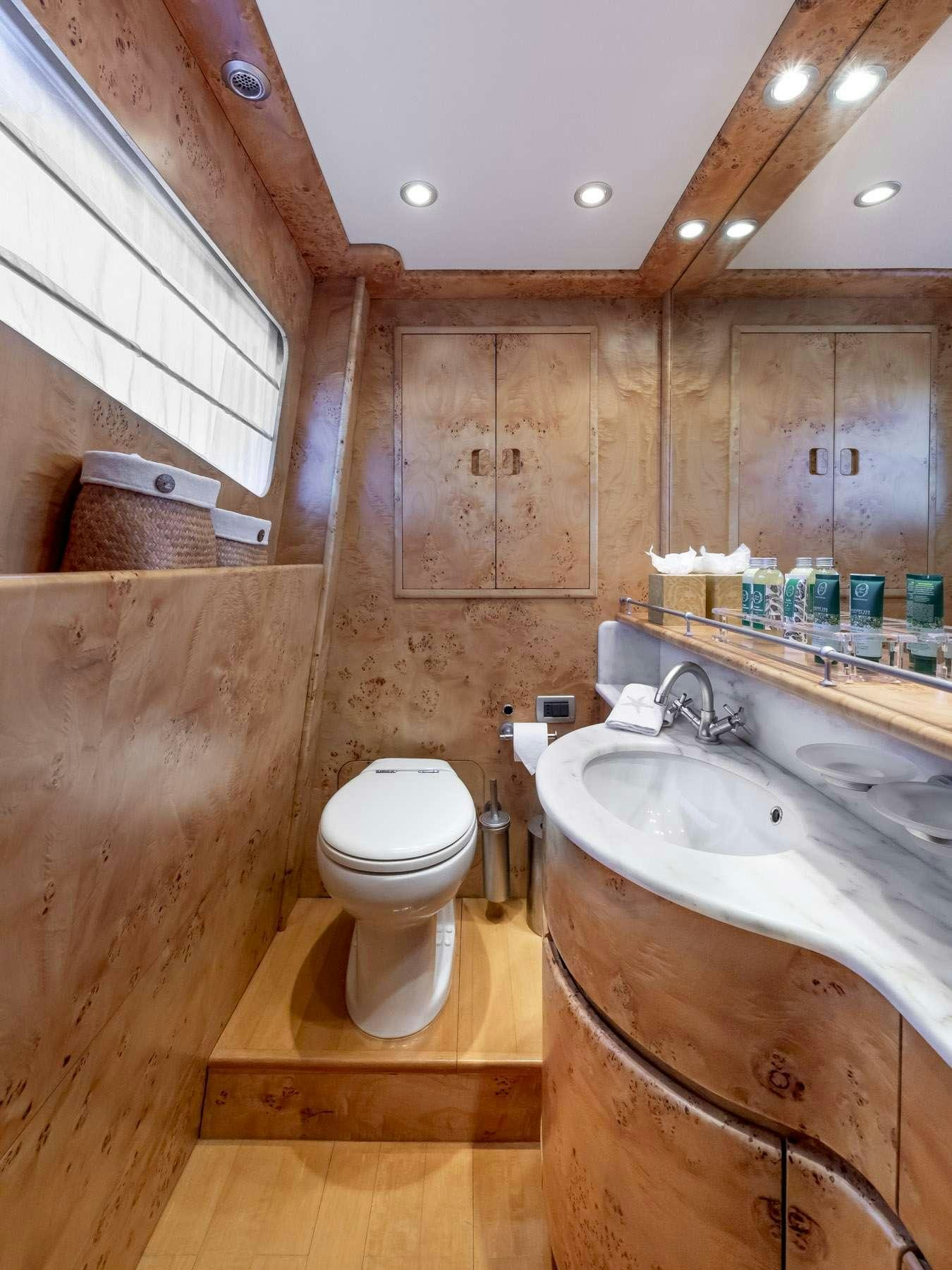 a bathroom with a sink toilet and a mirror aboard ANDILIS Yacht for Charter