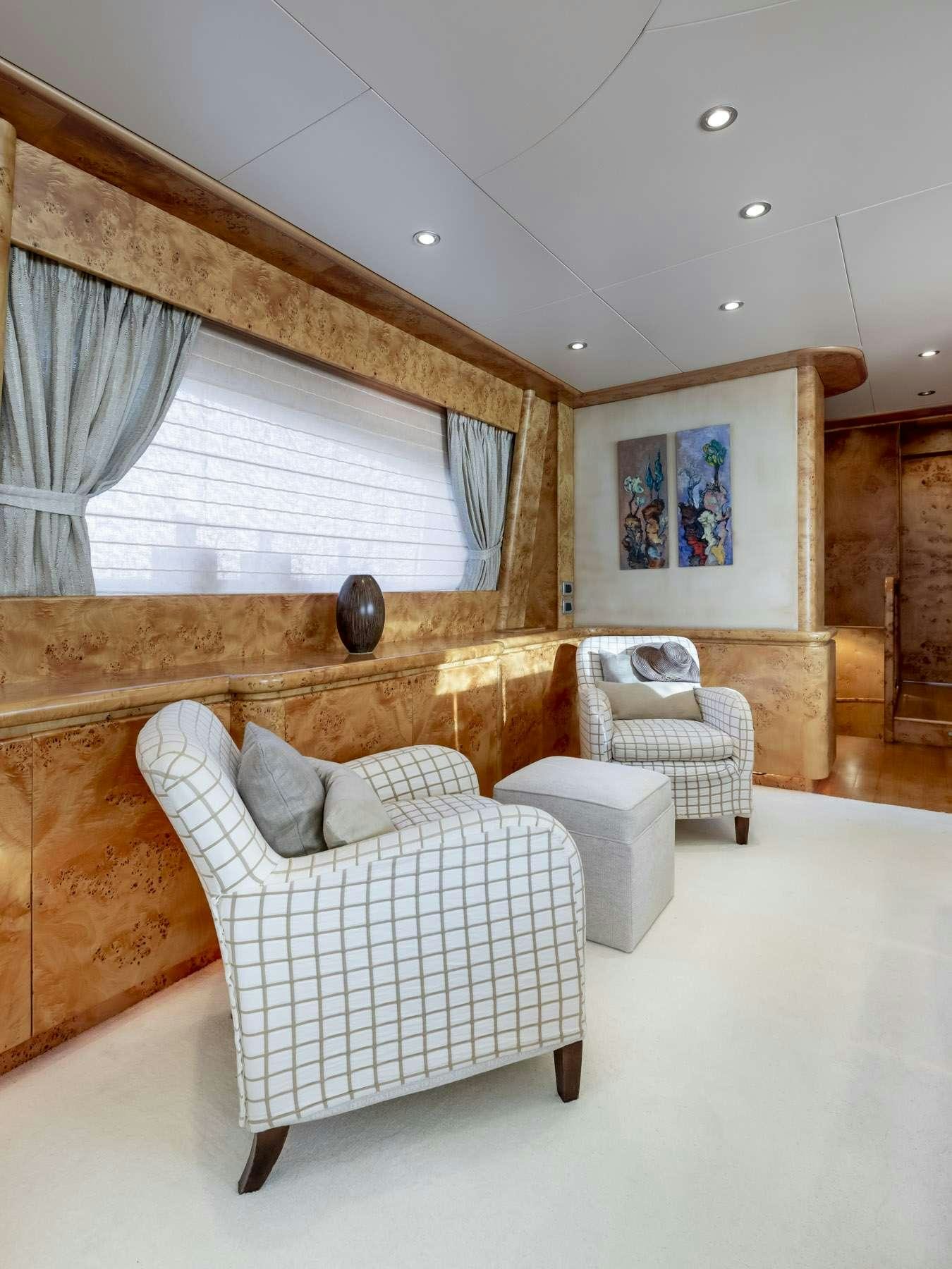 a room with a couch and a fireplace aboard ANDILIS Yacht for Charter