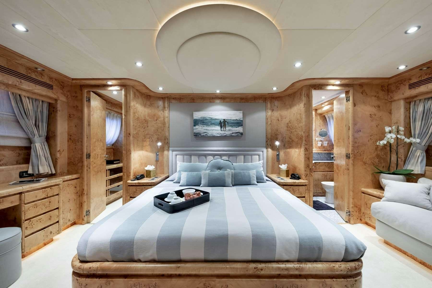 a large bedroom with a large bed aboard ANDILIS Yacht for Charter