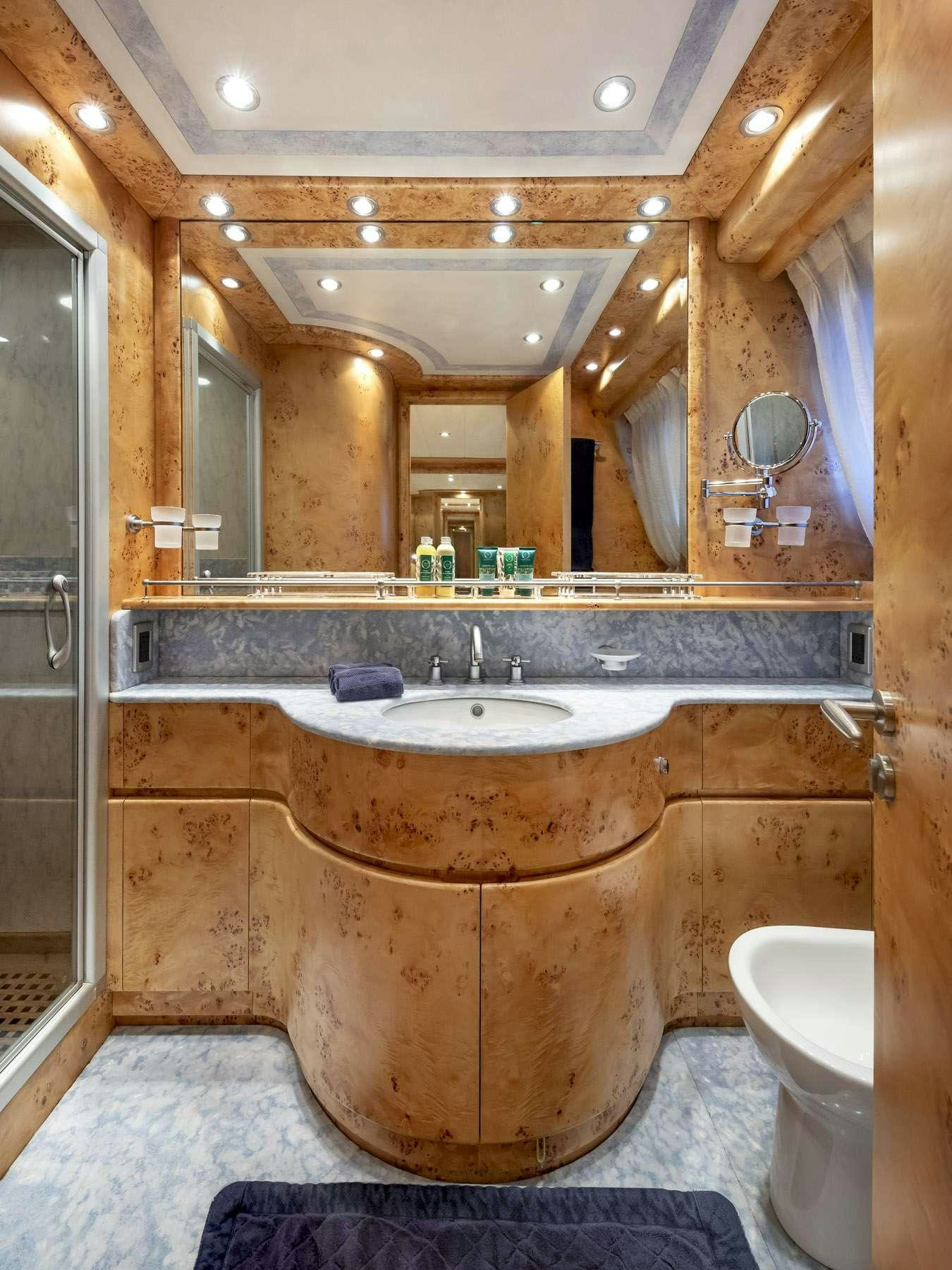 a bathroom with a large mirror aboard ANDILIS Yacht for Charter