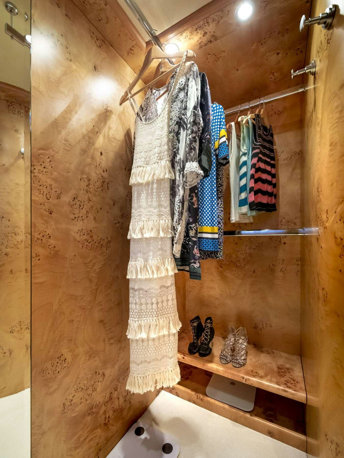 a shower with clothes on the wall aboard ANDILIS Yacht for Charter