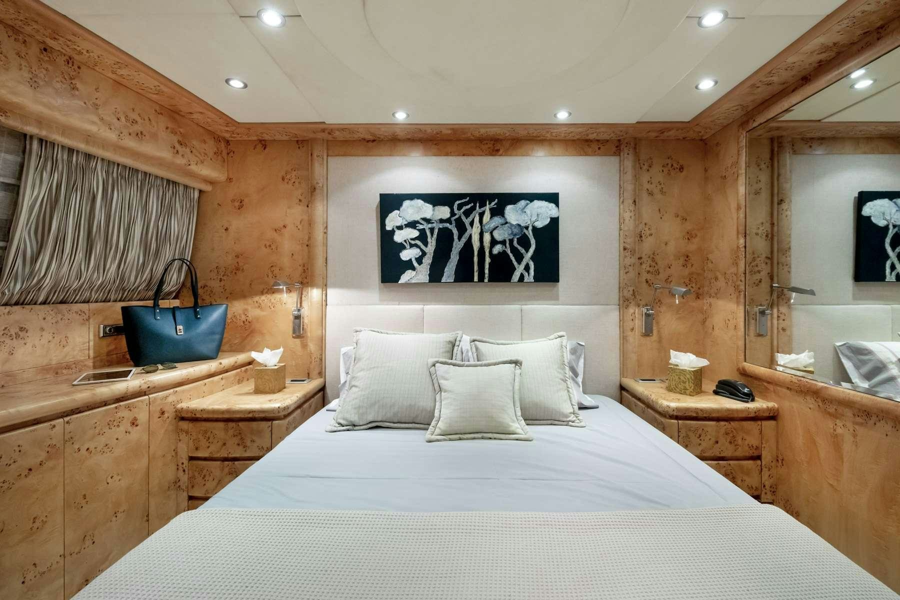 a bed with a white bed spread aboard ANDILIS Yacht for Charter