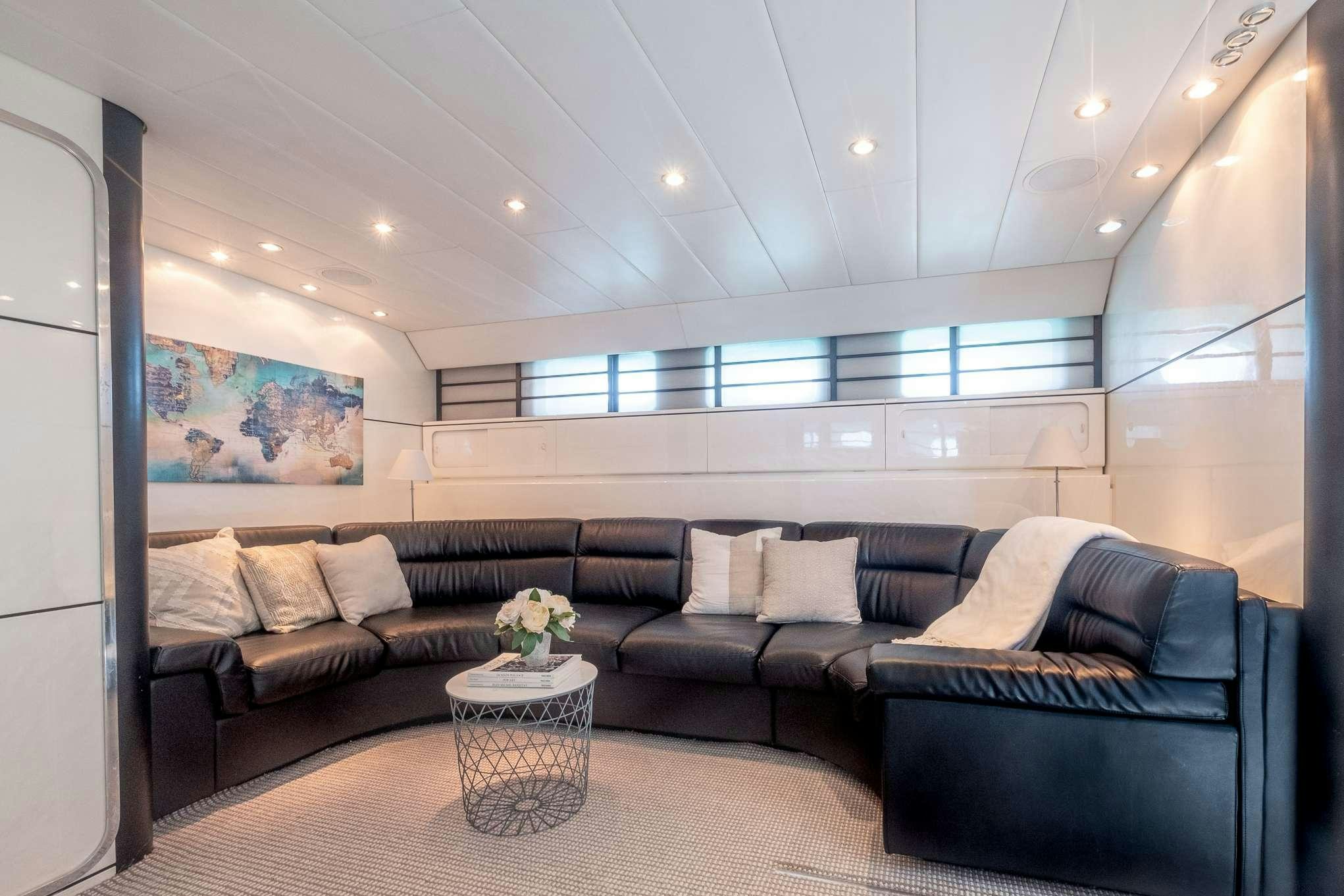 a living room with a couch and a coffee table aboard EMILIA Yacht for Charter