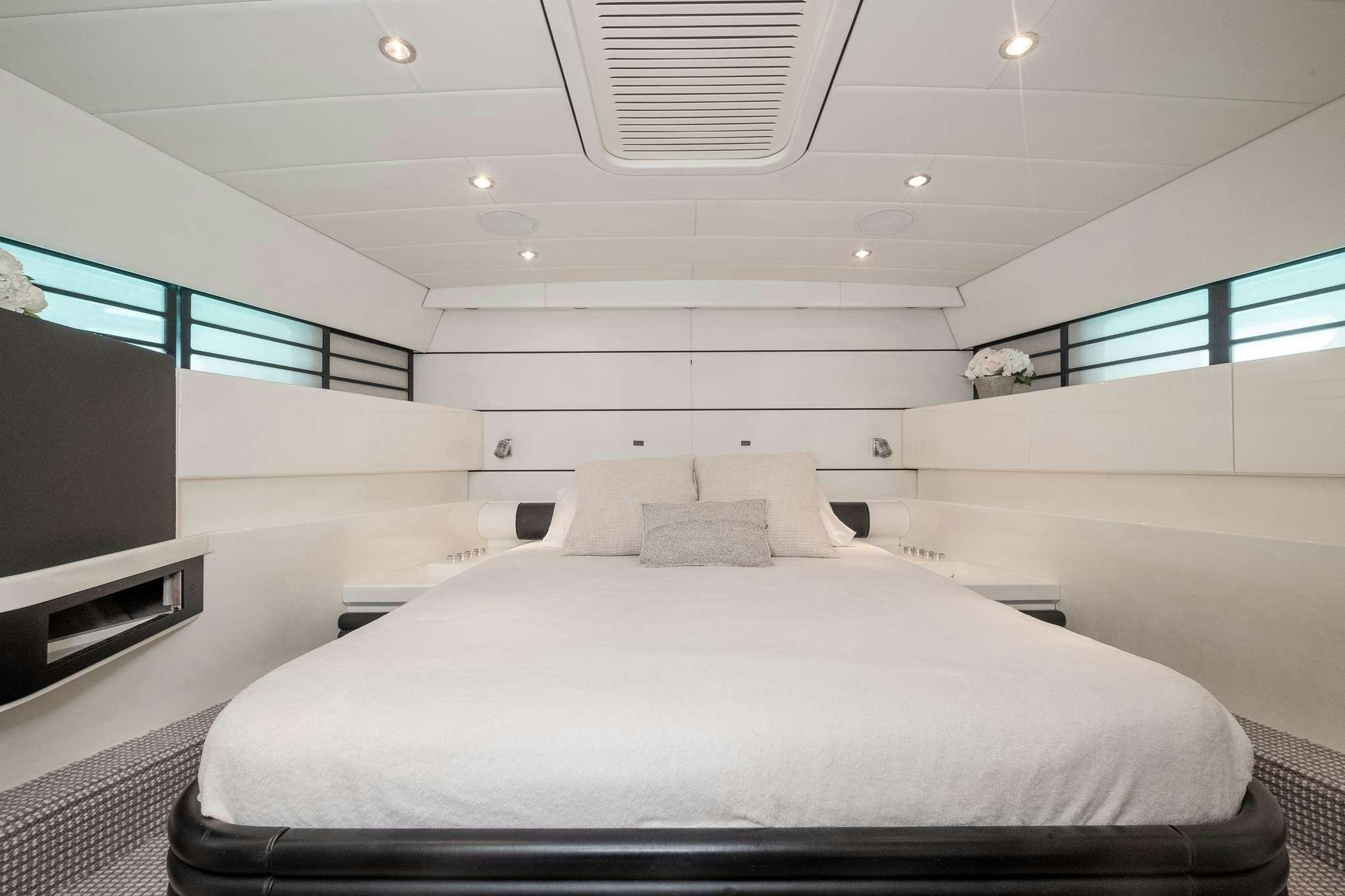 a large white bed in a room aboard EMILIA Yacht for Charter