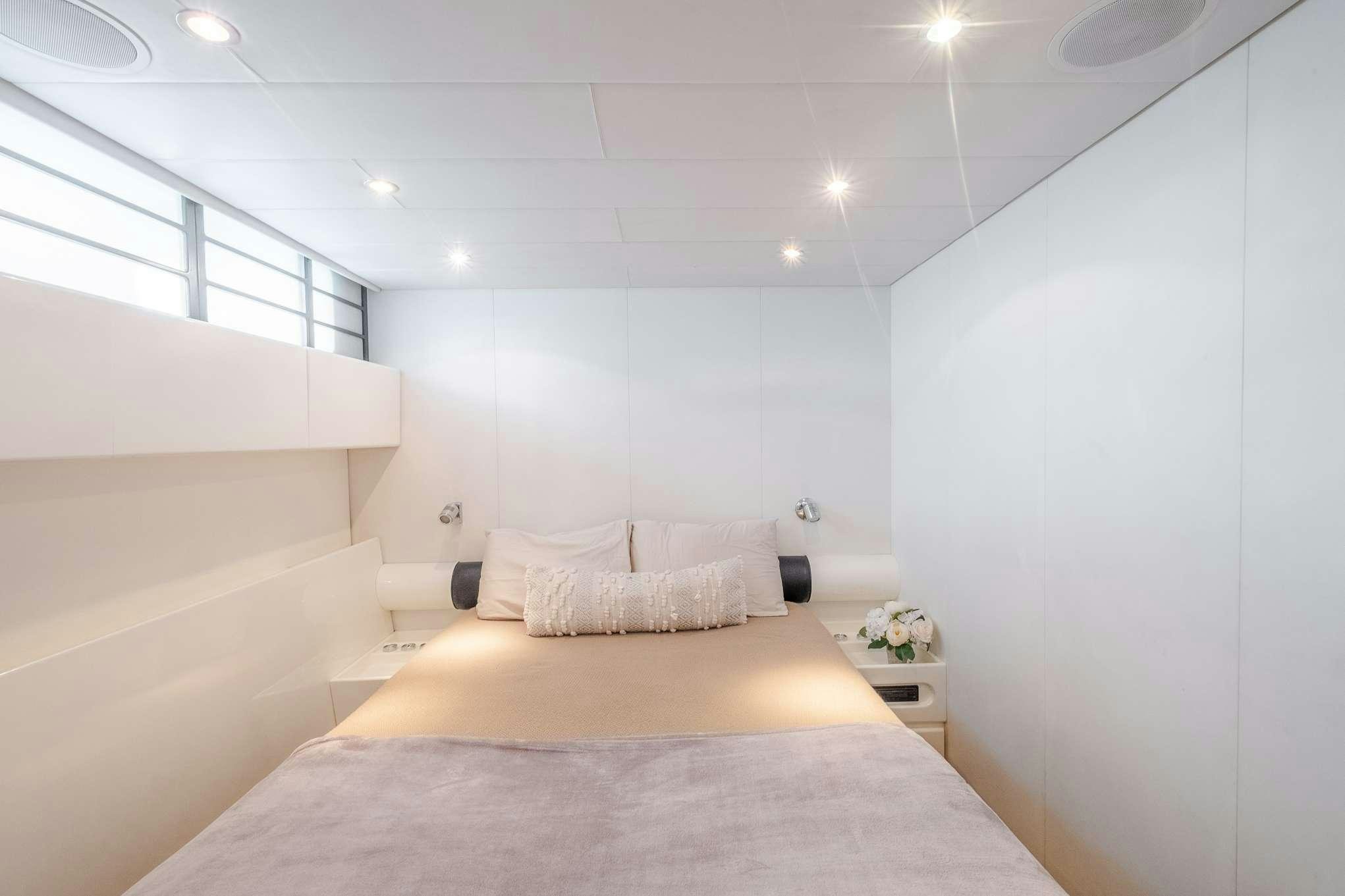 a bedroom with a bed aboard EMILIA Yacht for Charter