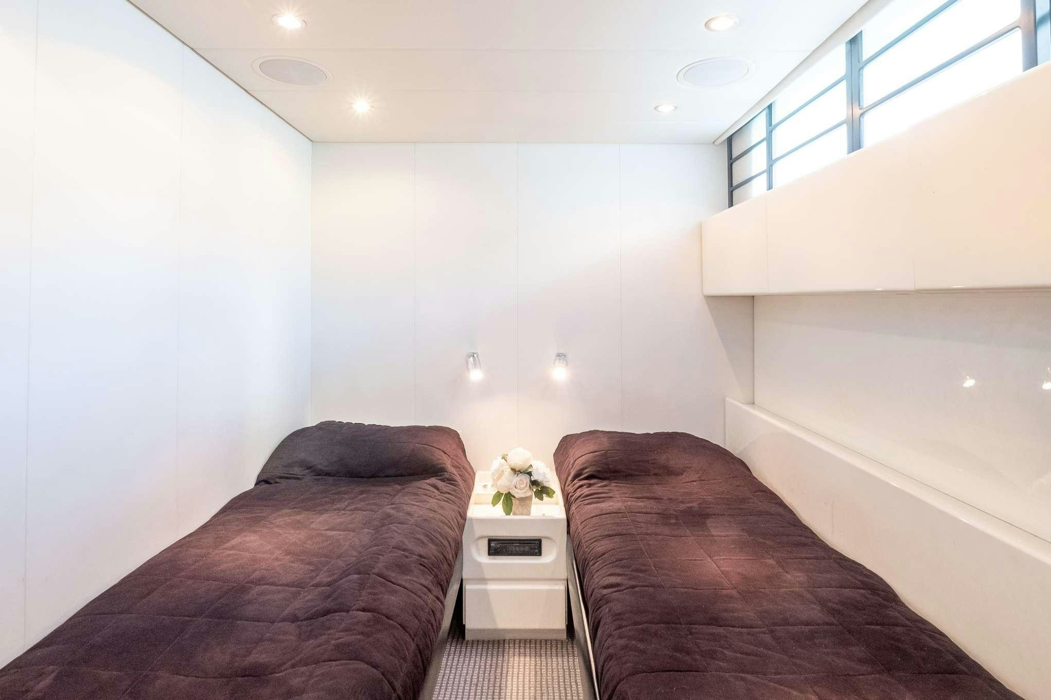 a bedroom with a bed and a window aboard EMILIA Yacht for Charter