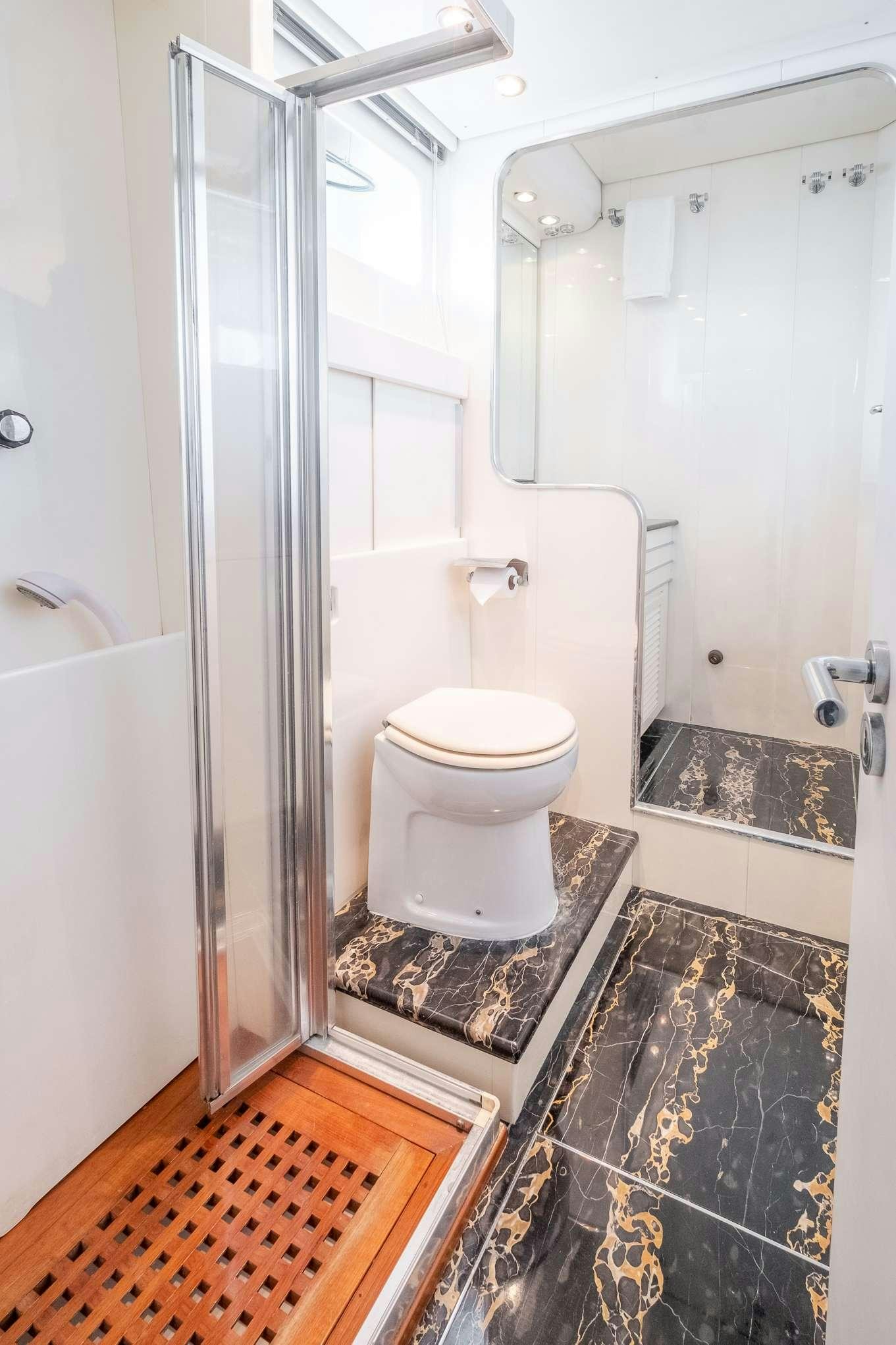 a bathroom with a toilet and a shower aboard EMILIA Yacht for Charter