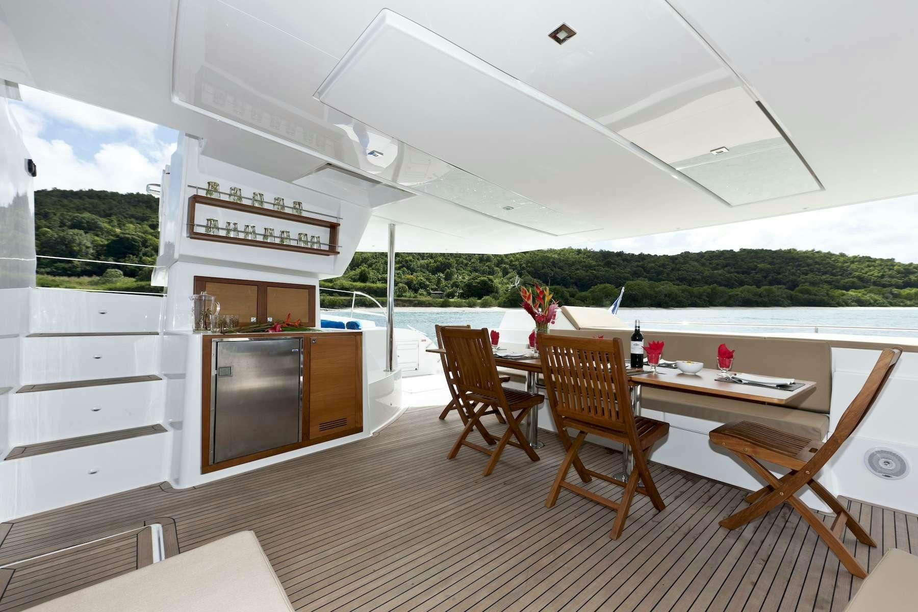 a room with a table chairs and a fireplace aboard TE MOANA - LUXURY TW59 Yacht for Charter