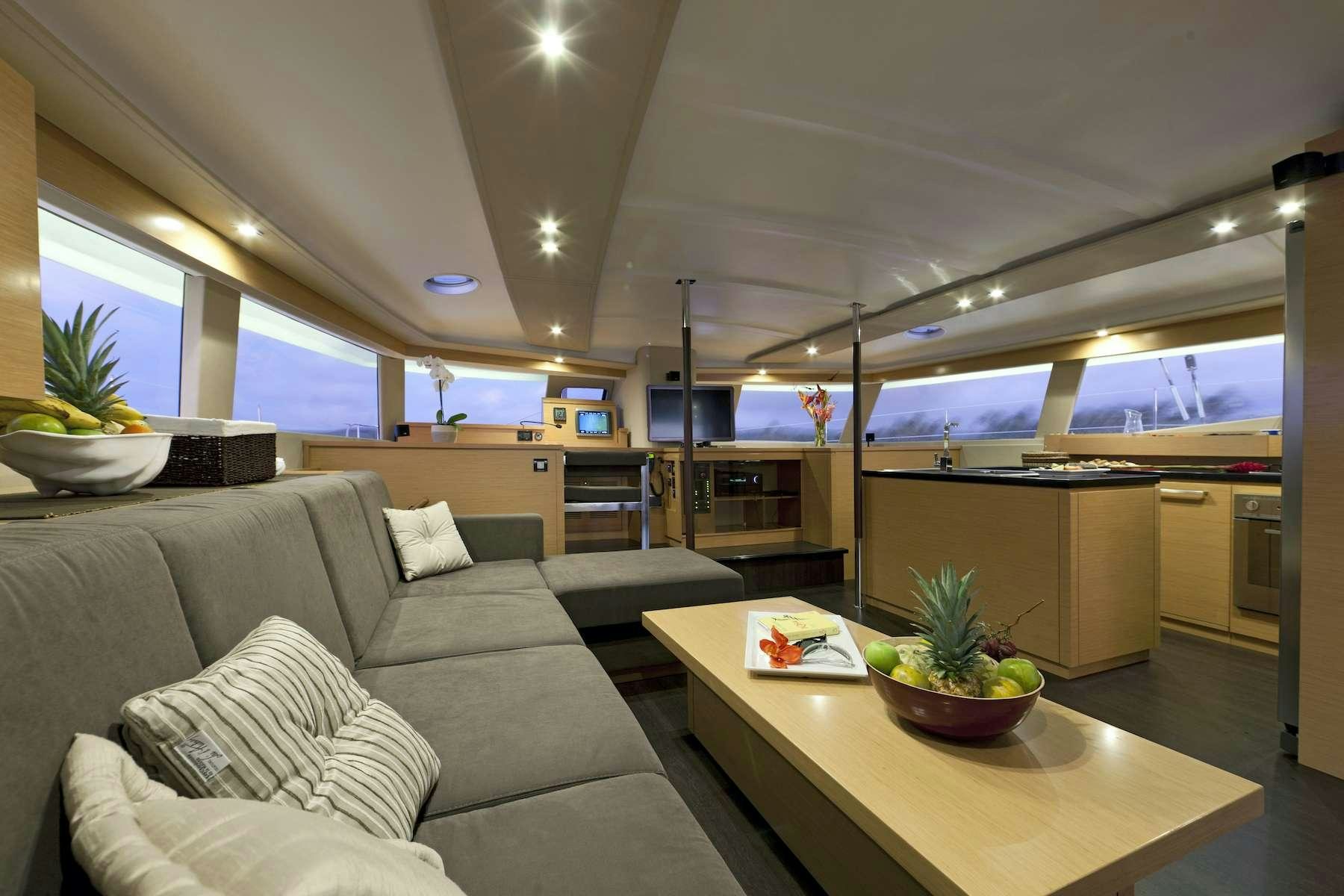 a living room with a couch and a table aboard TE MOANA - LUXURY TW59 Yacht for Charter