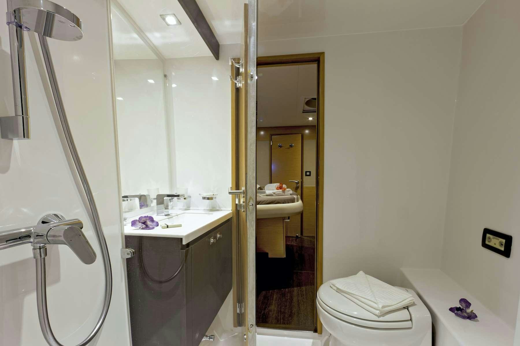 a bathroom with a glass shower aboard TE MOANA - LUXURY TW59 Yacht for Charter