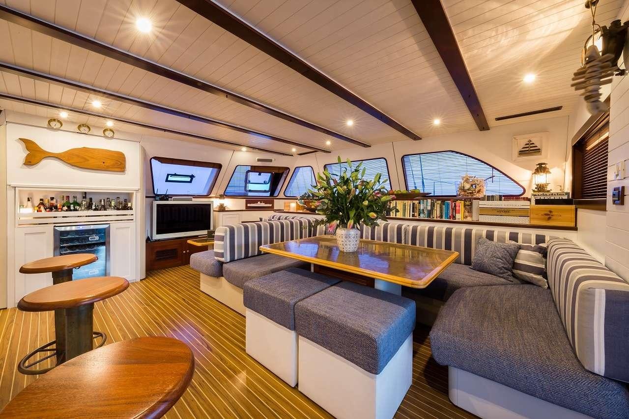 a living room with a couch and a table aboard OMBRE BLU³ Yacht for Charter