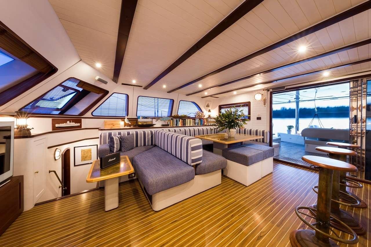 a living room with a large window aboard OMBRE BLU³ Yacht for Charter