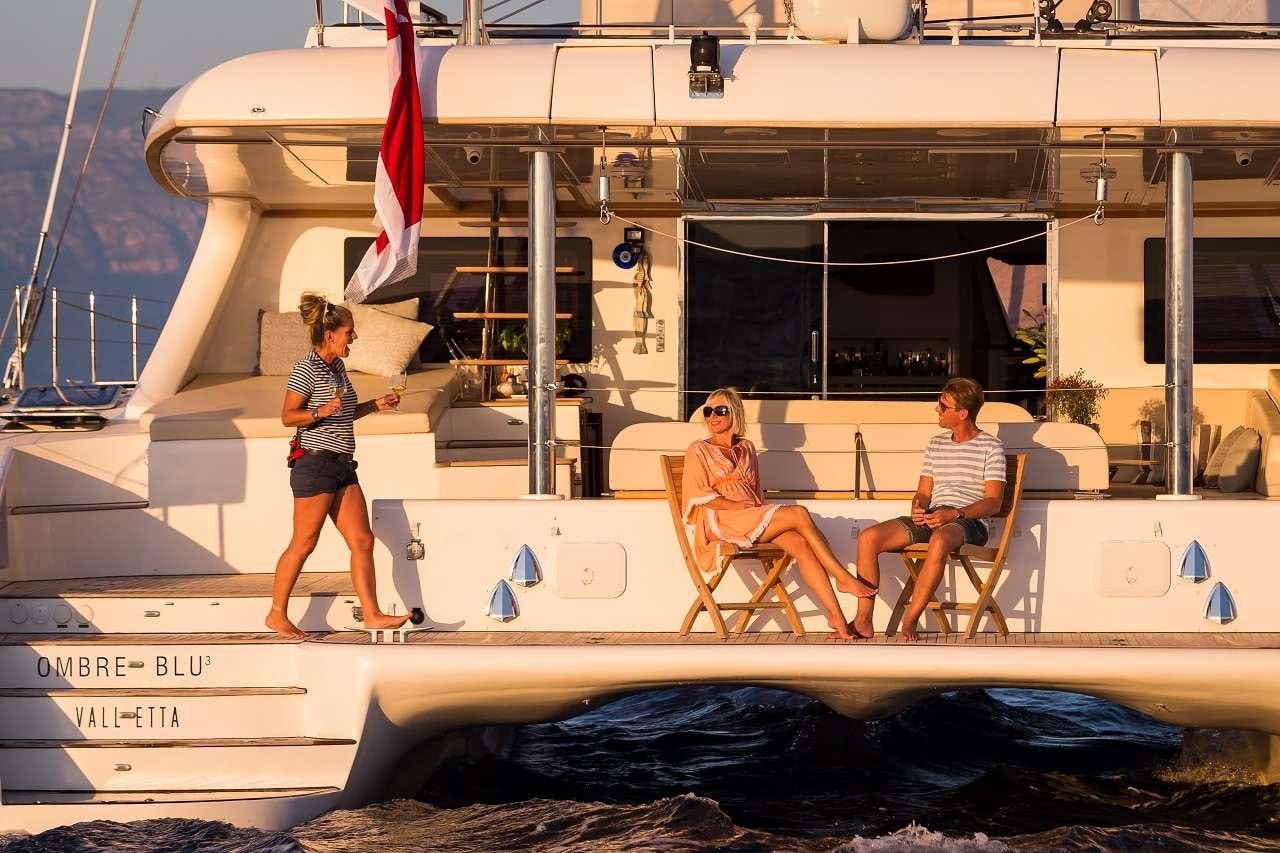 a couple of people on a boat aboard OMBRE BLU³ Yacht for Charter
