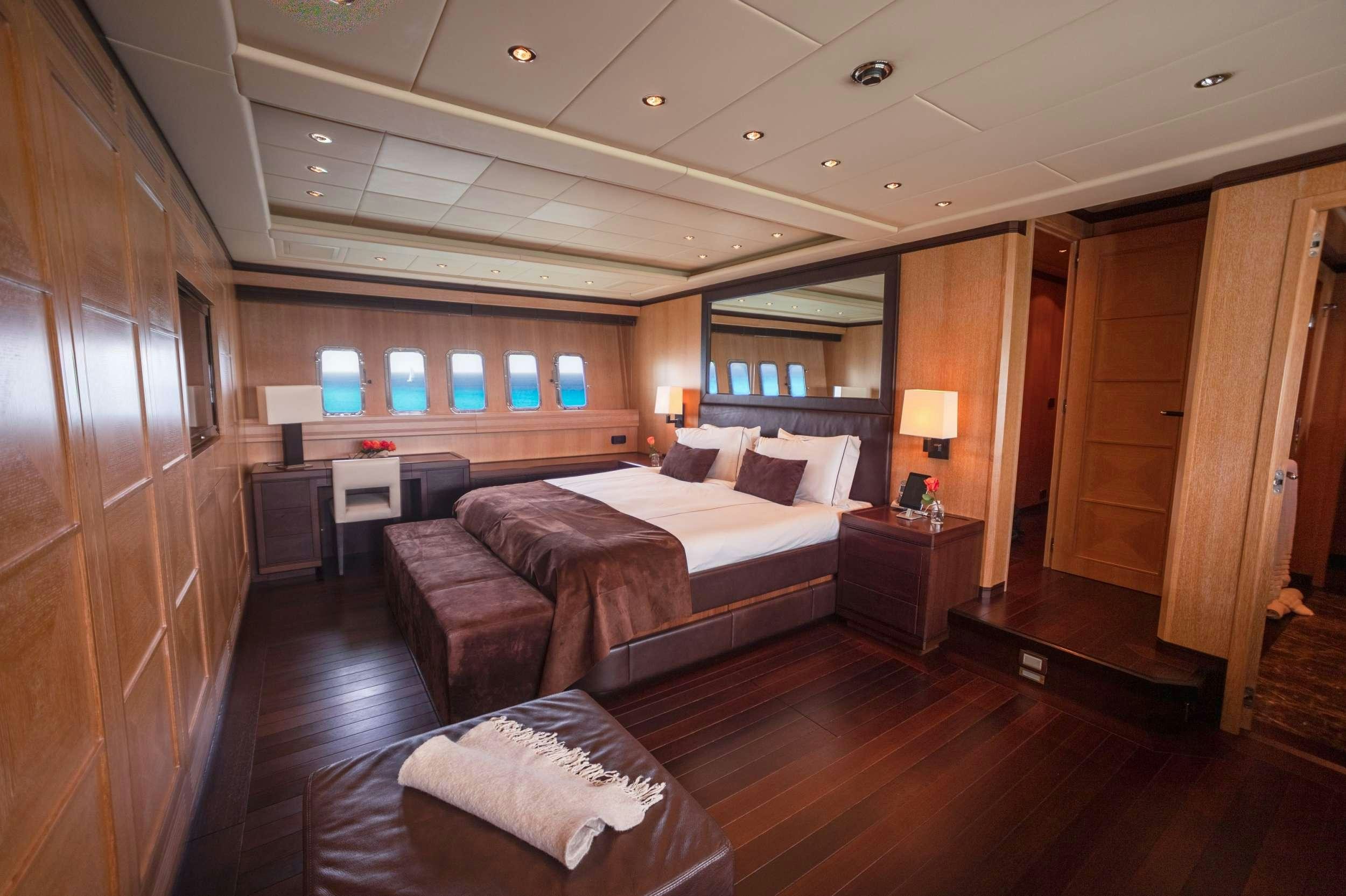 a bedroom with a bed and a desk aboard FREE SPIRIT Yacht for Charter