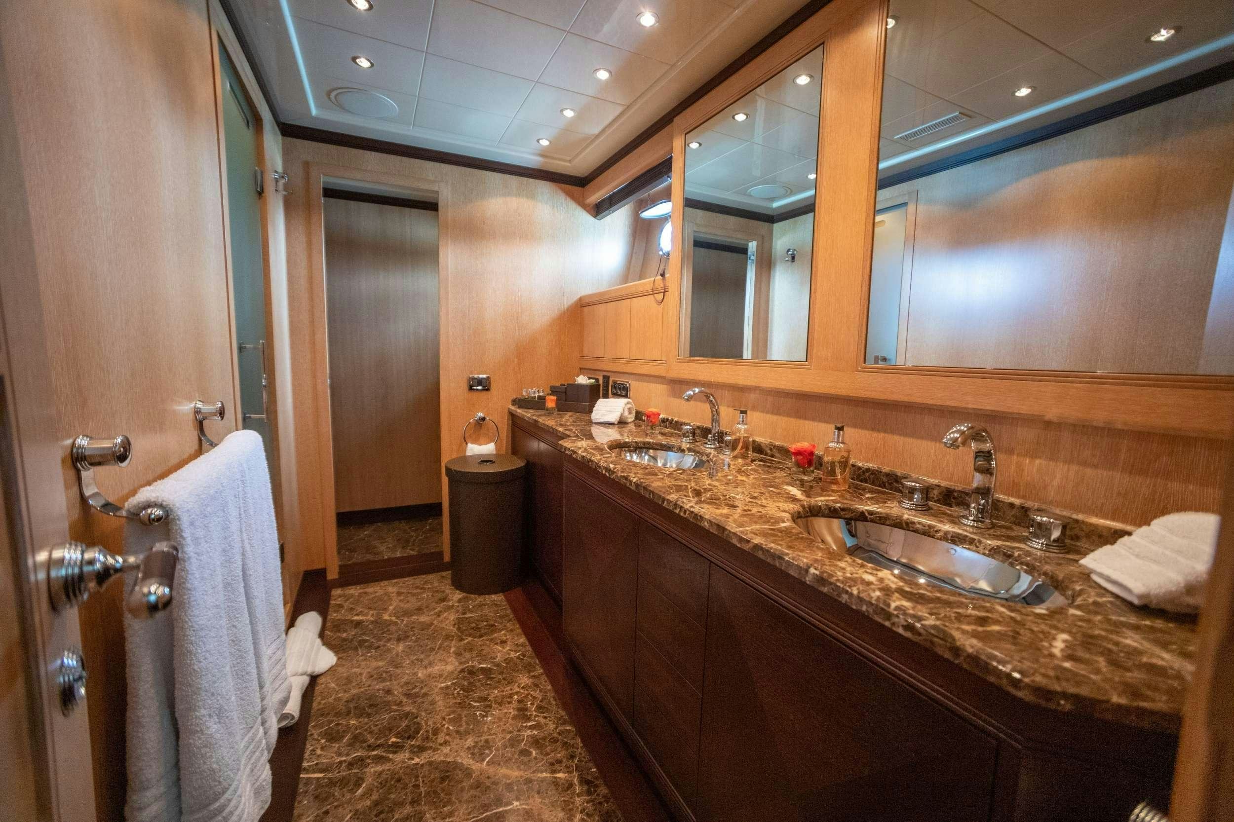 a bathroom with a countertop sink and mirror aboard FREE SPIRIT Yacht for Charter